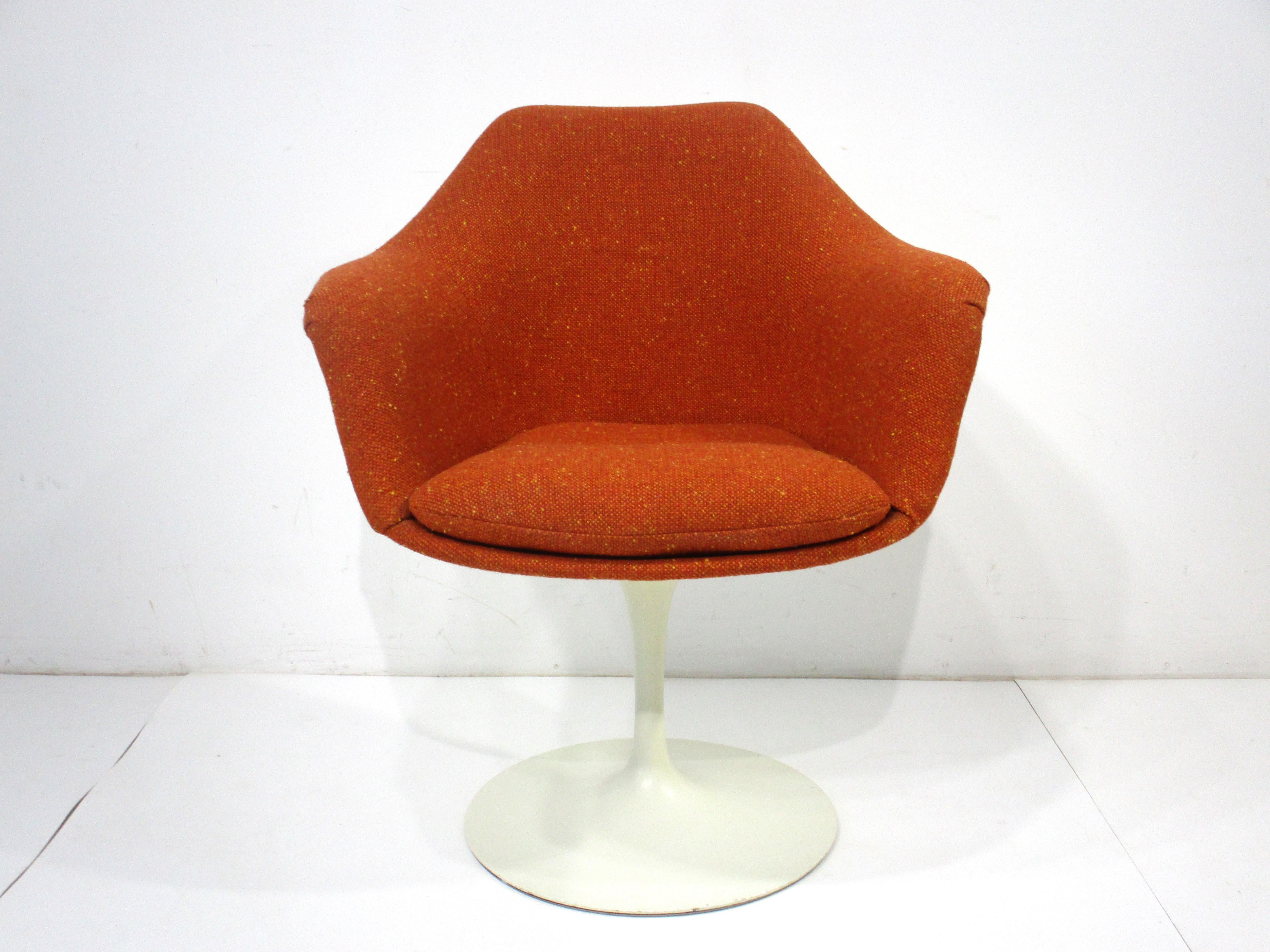 A special order upholstered tulip arm chair with nice curved back and supportive bottom seat cushion . This is a very comfortable chair for hours of relaxing at home or in the office with a white non swiveling base . Designed by Eero Saarinen for