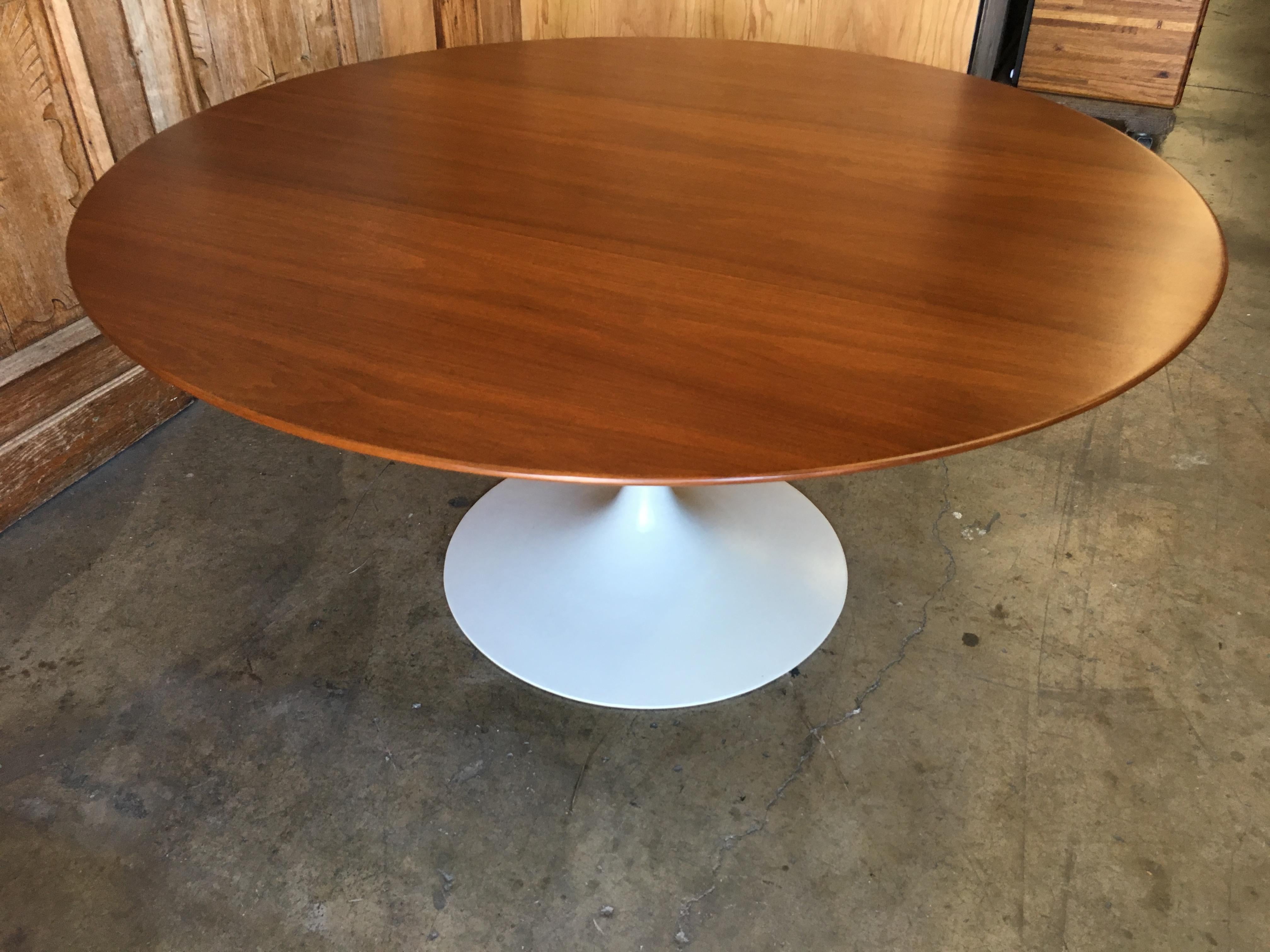 Walnut topped dining table with beveled edge and off white metal base.