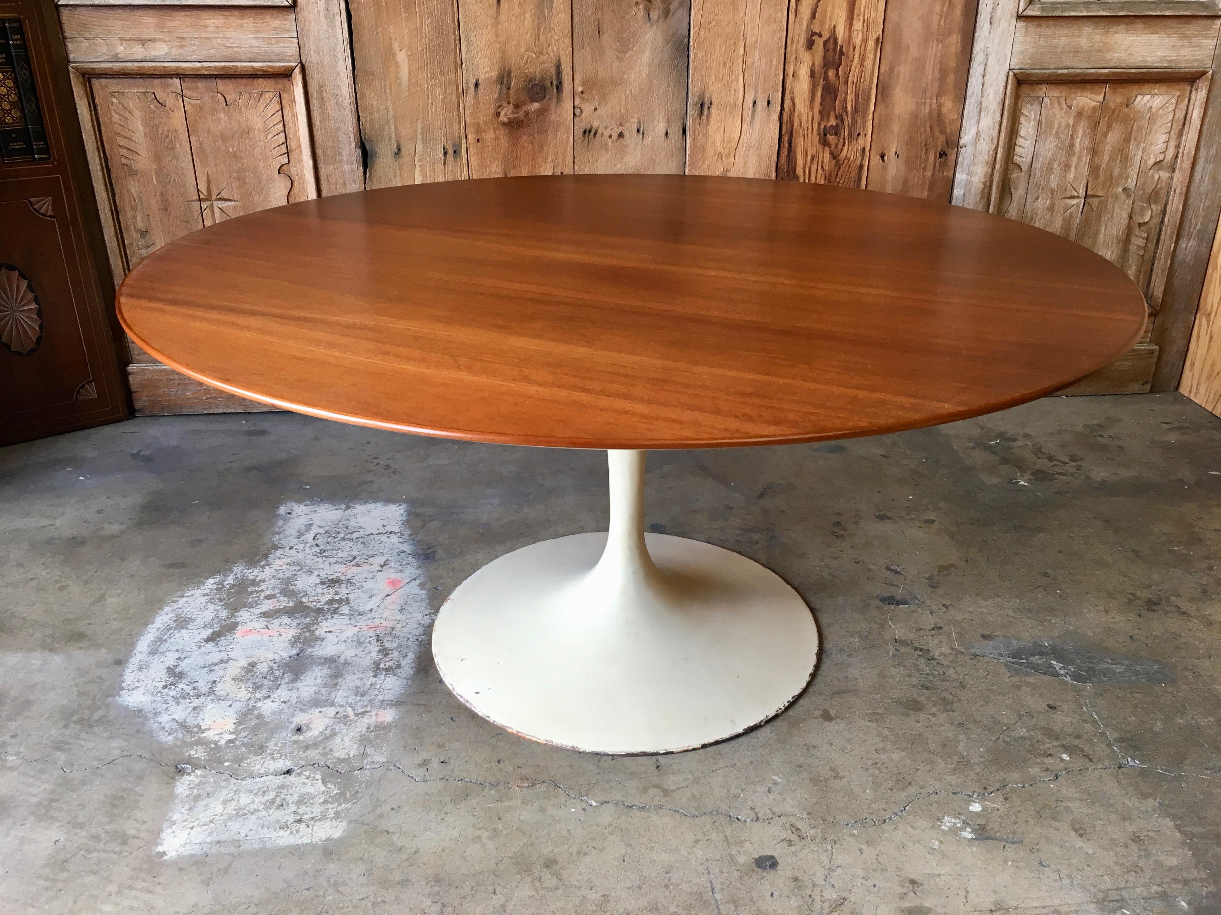 Walnut topped dining table with beveled edge and off white metal base.