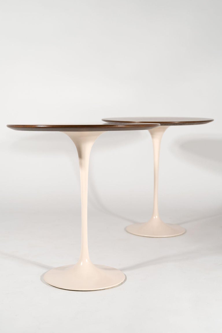 Pair of Knoll side tables designed by Eero Saarinen. Antique white bases and refinished walnut tops.
Knoll International label intact. These are the very heavy early cast examples. Much higher manufacturing quality than the newer examples.