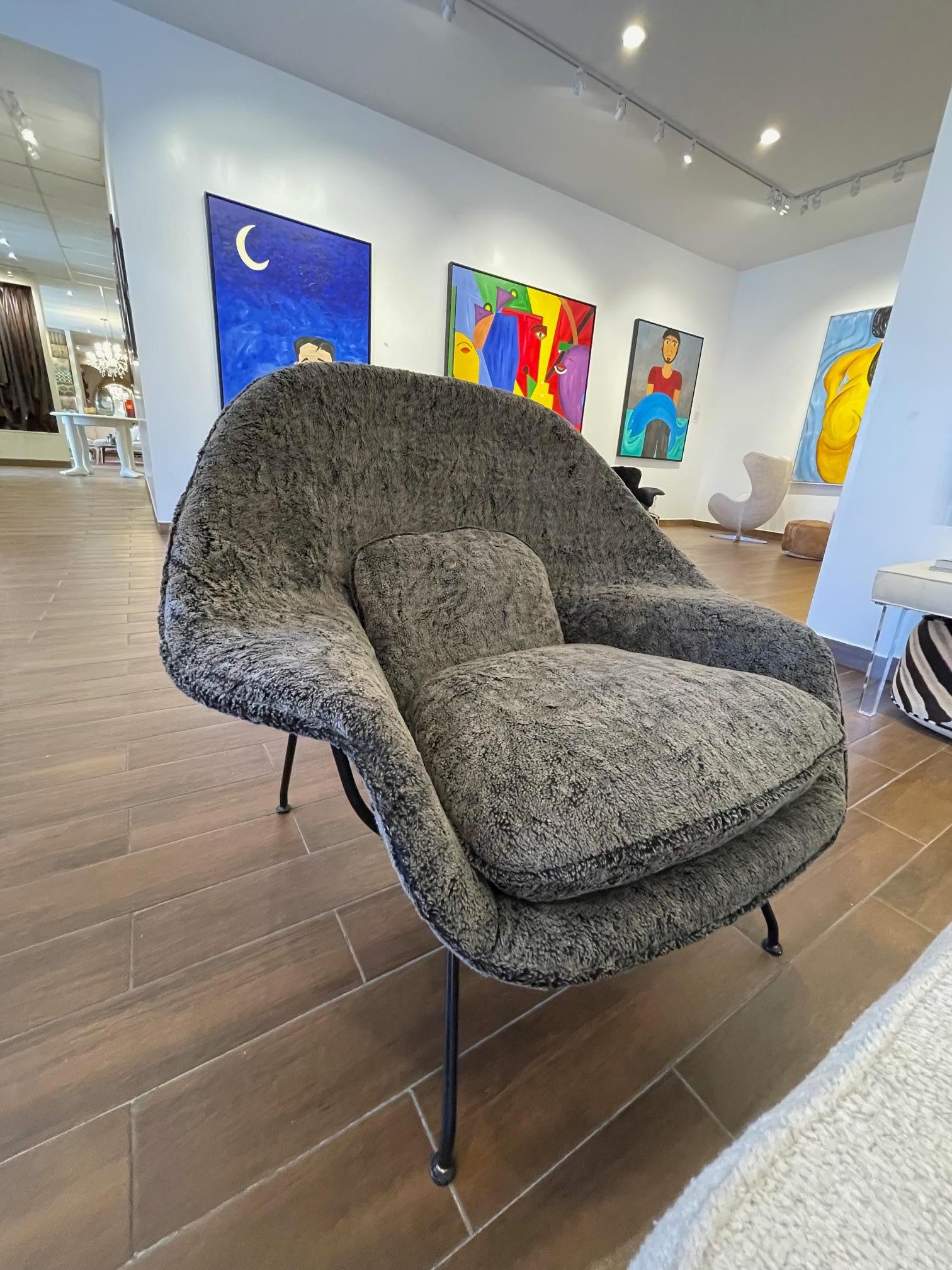 Sink into effortless comfort with the iconic Eero Saarinen Womb Chair, reimagined in luxurious charcoal grey boucle. Perfectly reupholstered with a plush feather and foam insert, this chair invites you to relax and unwind in style. Its timeless