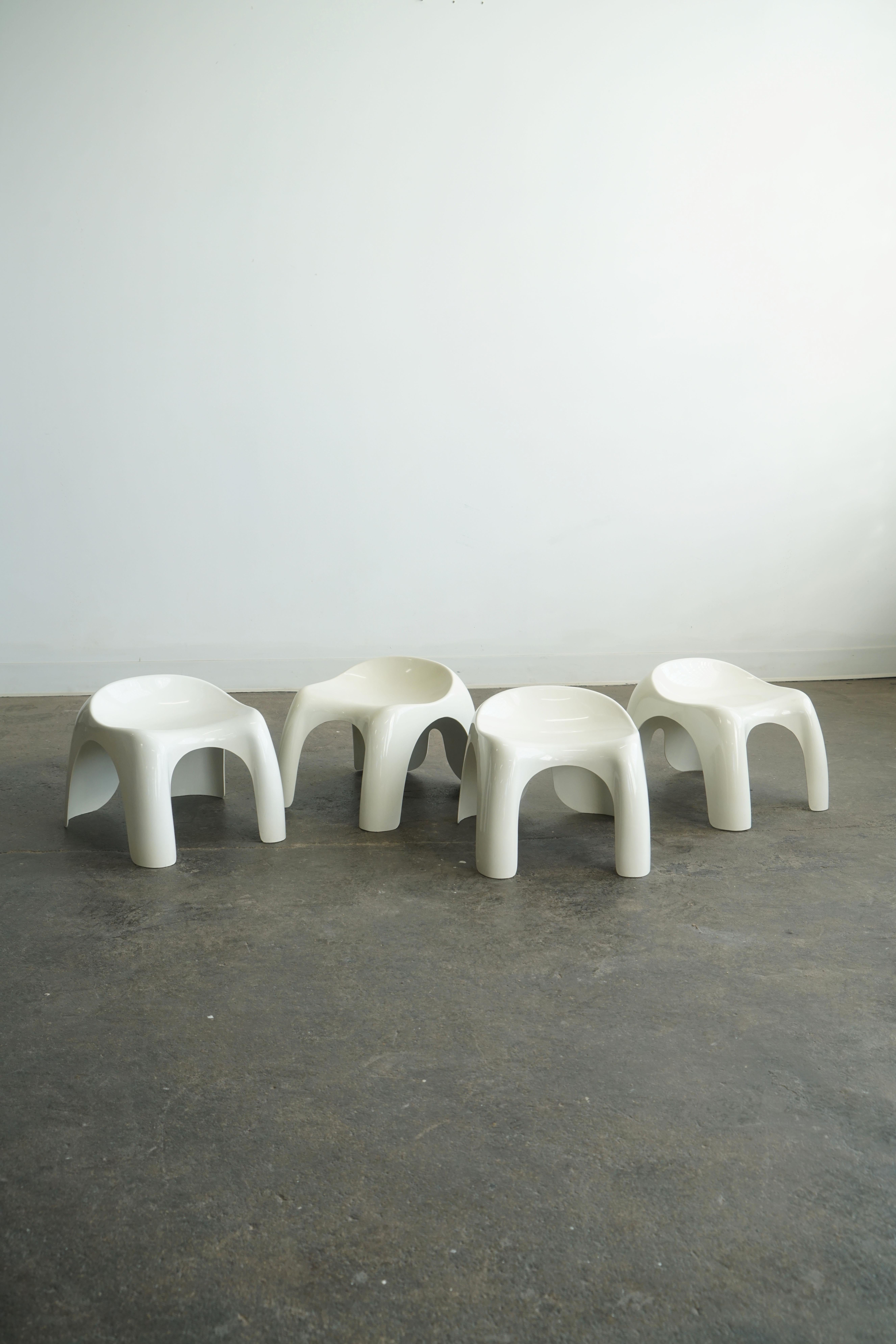 Efebo Seats designed by Stacy Duke for Artemide.
Italy, 1960's
Golden plastic. 
Priced individually. Four available. 

These sculptural white molded plastic stools were designed as child stools, but even for adults, are very strong. 
Stamped label