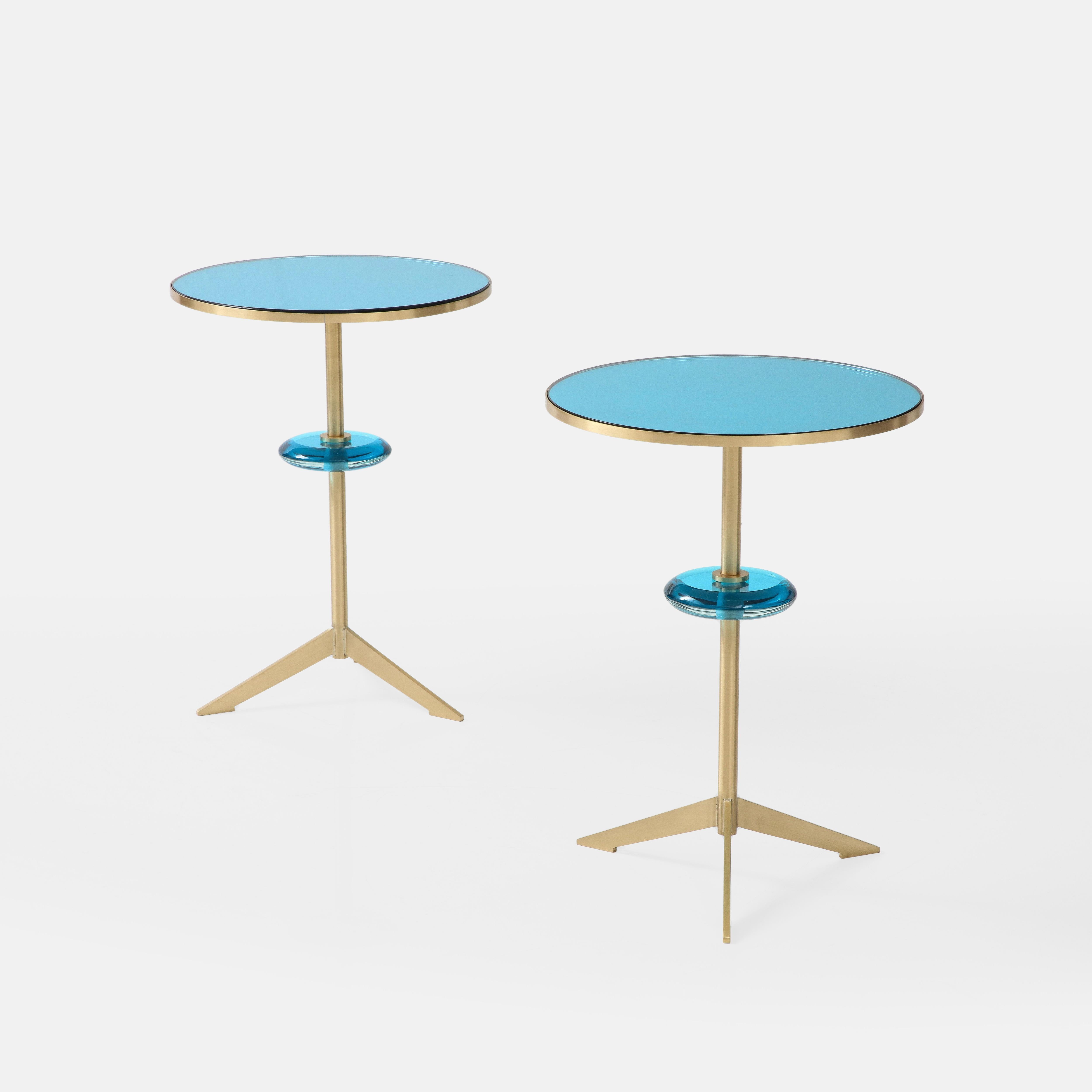 Effetto Vetro exquisite custom contemporary pair of round side tables with mirrored colored glass top inset on satin brass tripod base with floating colored glass orb suspended on brass stem. This lovely pair (or single) of modernist sculptural side