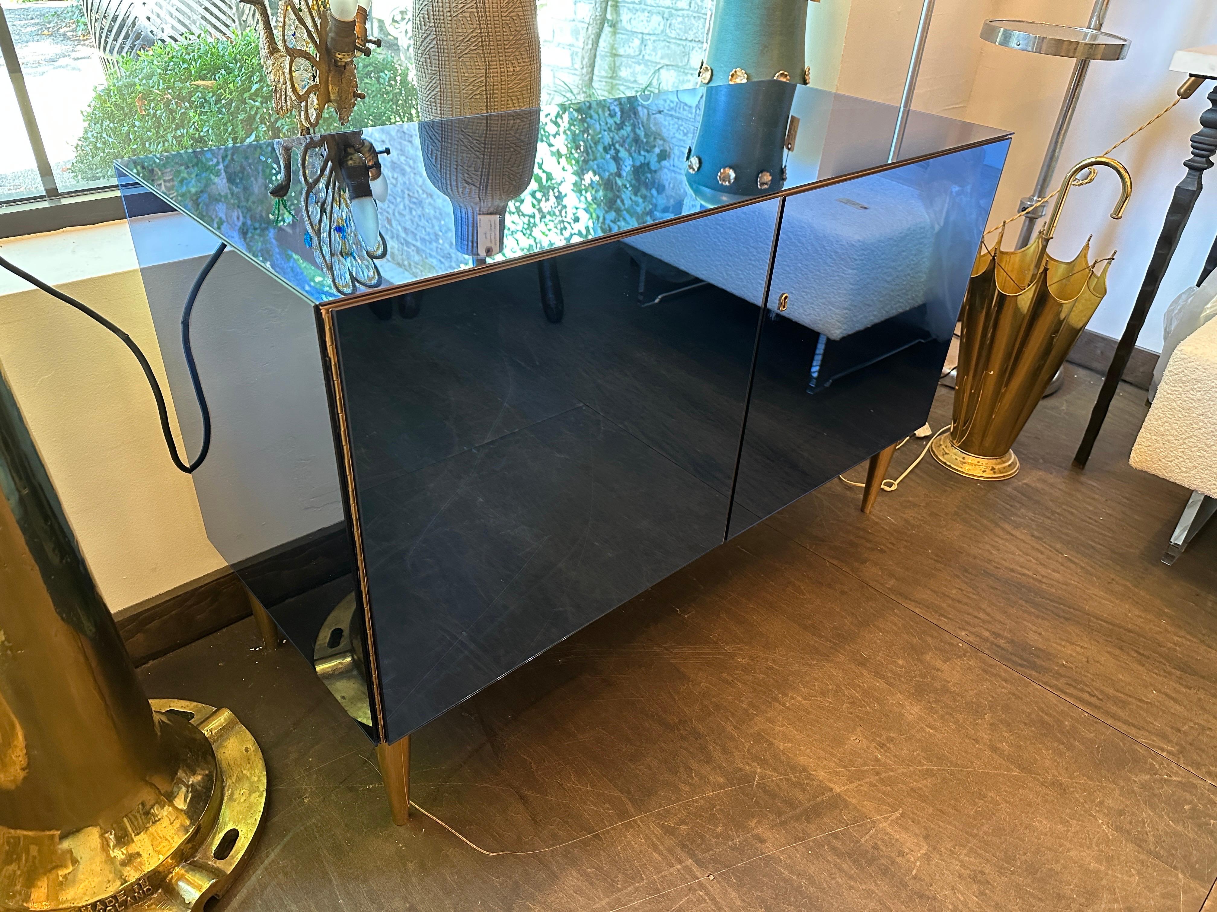 This custom made cabinet by Effetto Vetro in Milan is of very high quality Italian craftsmanship.  Beautiful details such interior casing in light woods, single shelf, solid bronze conical legs and a mirror clad matching key.  NOTE:  we have TWO