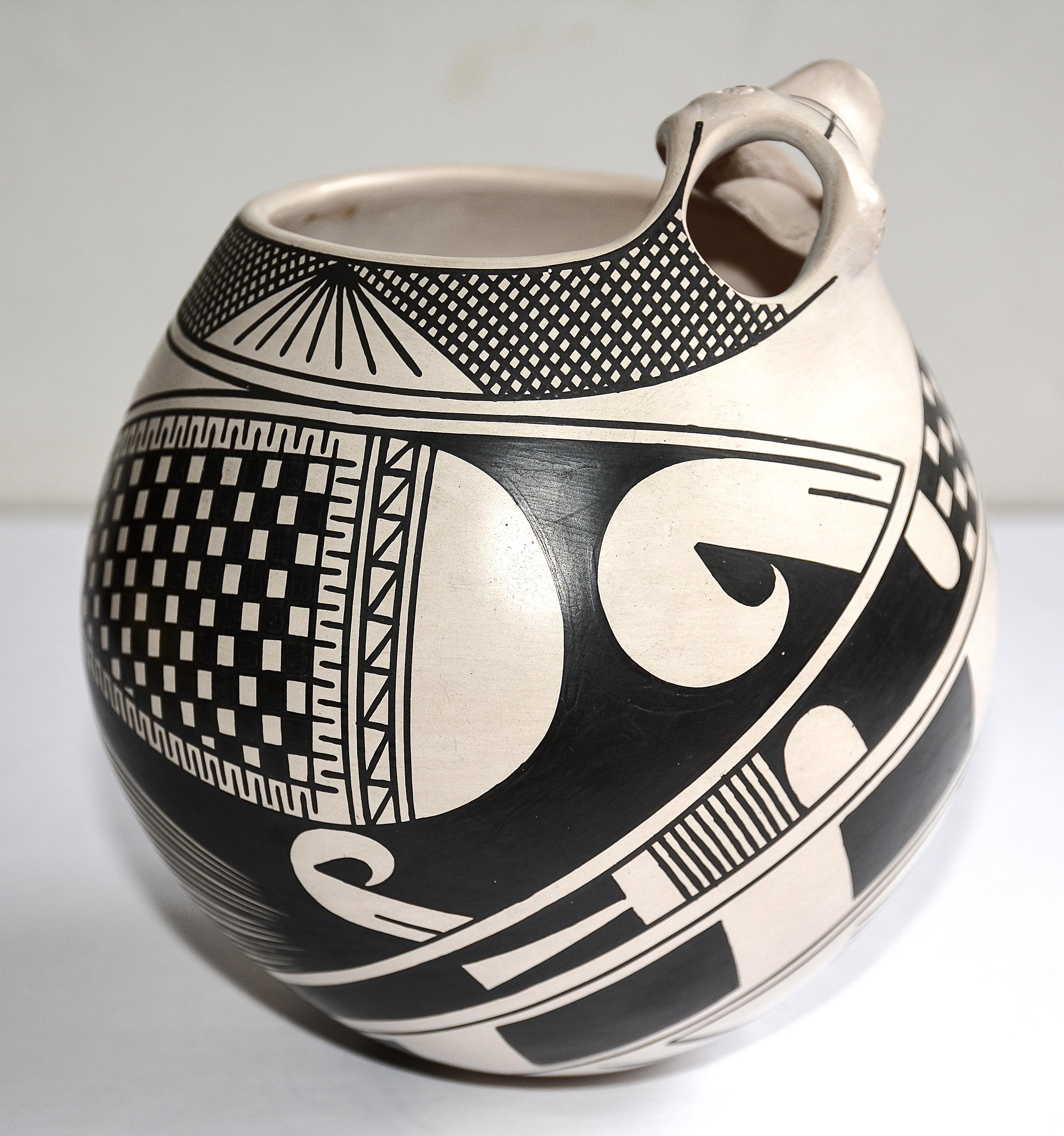 White slip black geometric effigy pot
Nicolas Quezada, Master Potter (1948 - 2011)
1988
Hand coiled low fired clay
Pueblo Quezada, Mata Ortiz, Chihuahua, Mexico
Measure: 6 inches H. x 5.5 inches in Diameter

Nicolas Quezada was the younger brother