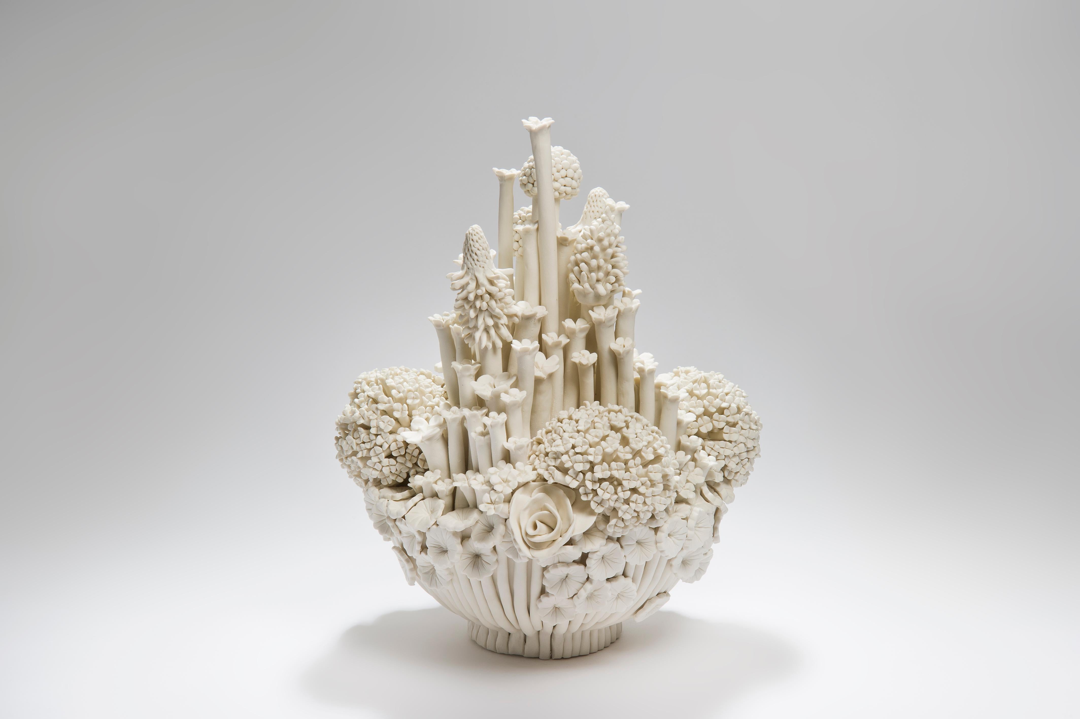 Efflorescence I, is a unique handcrafted porcelain sculpture completely covered in a multitude of individually made porcelain flowers of all different shapes and forms by the British artist Vanessa Hogge.

Vanessa Hogge breathes life into her clay