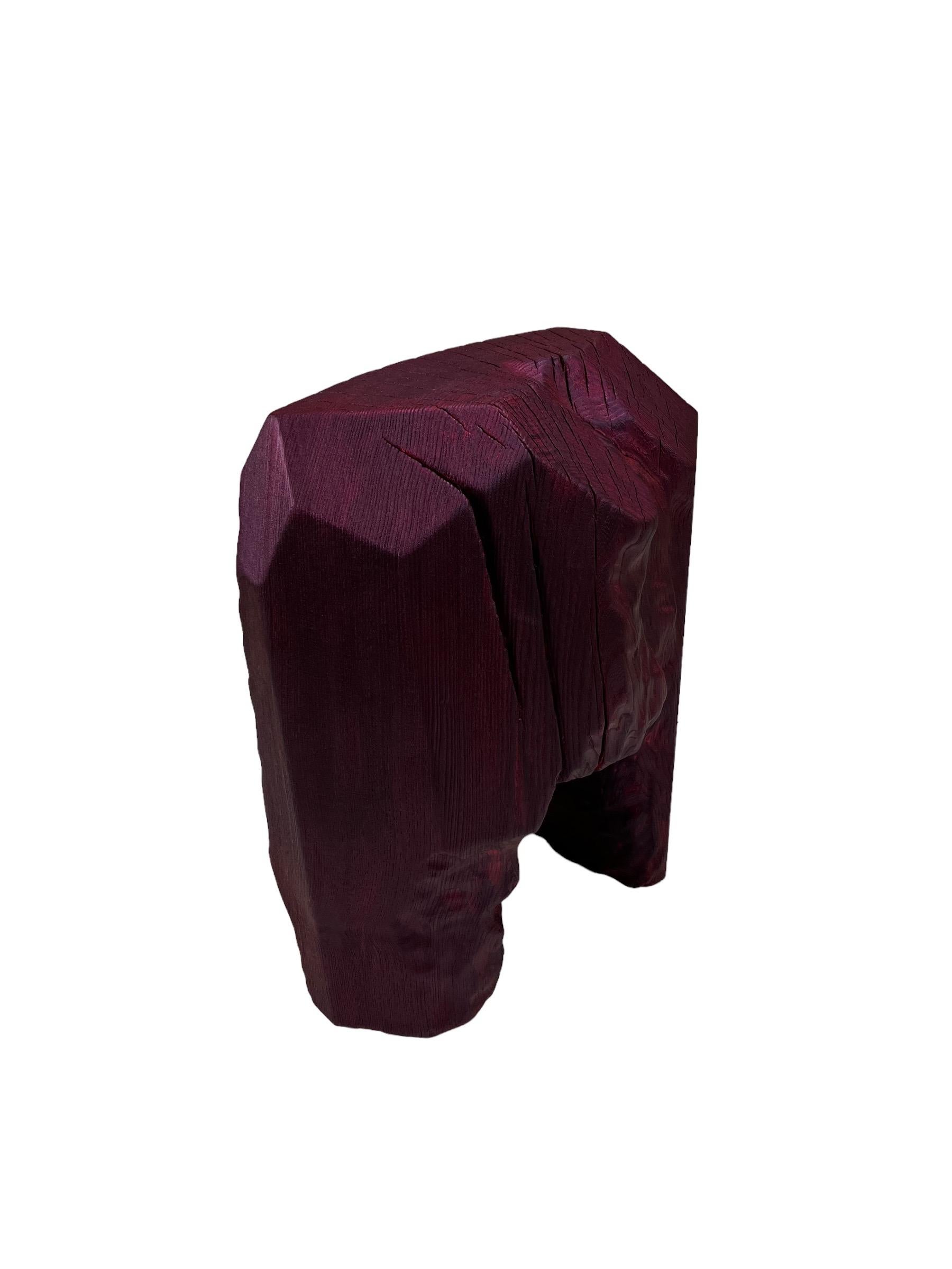 Carved wooden stool from locally sourced elm wood from the lanscape of Småland .
Hand carved by master Swedish woodmaker ELAKFORM. 
Painted by hand with a durable acrylic-based colour and finished with an acrylic lacquer.
The special Burgundy paint