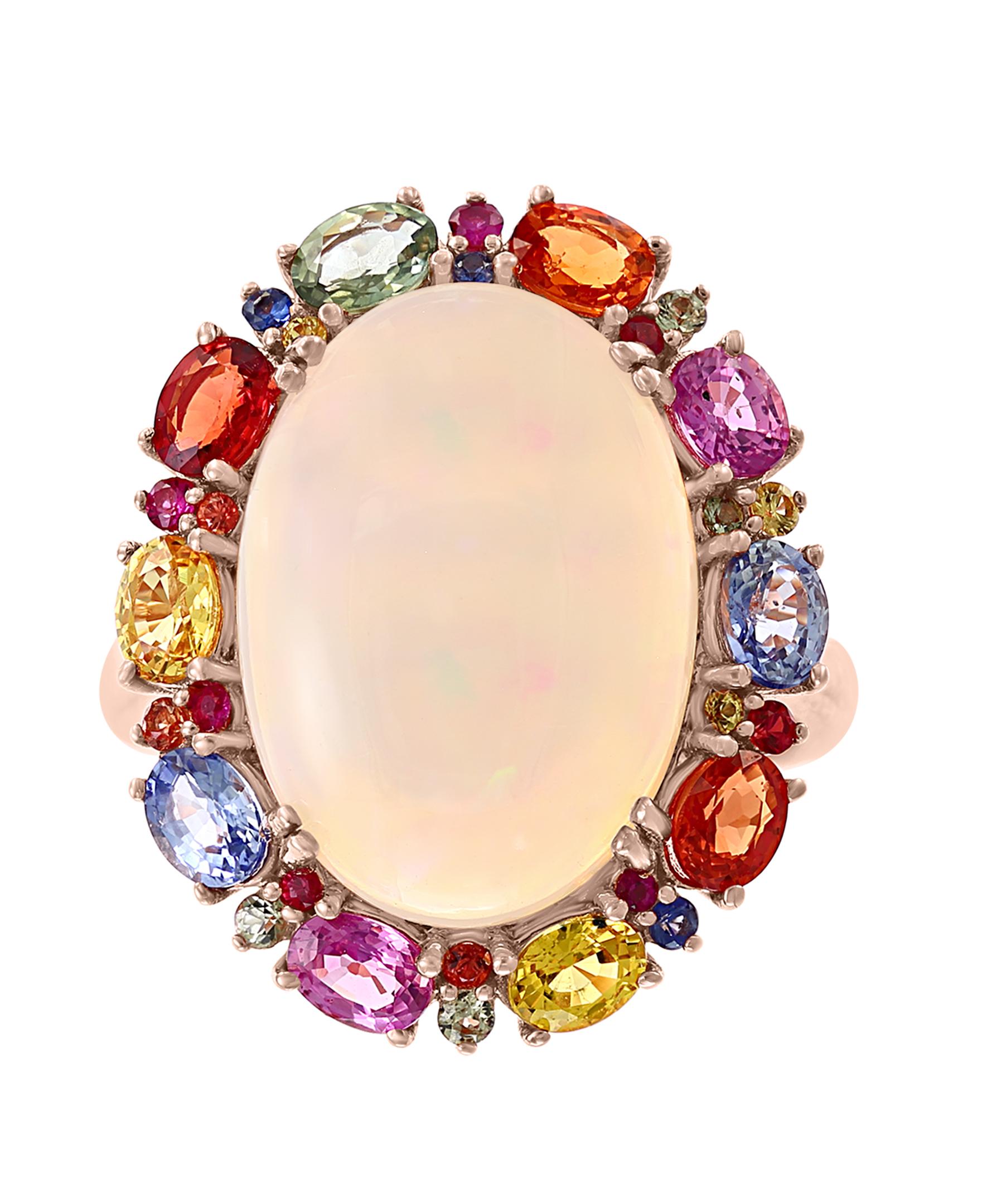 This Effy design ring is set in 14K rose gold. 
The center stone is an oval shape Opal and the weight is 6.67 ct.
The multicolor sapphires are round and oval in shape and the total weight is 2.73 ct.
This ring is a sizable 7. 
The item number is