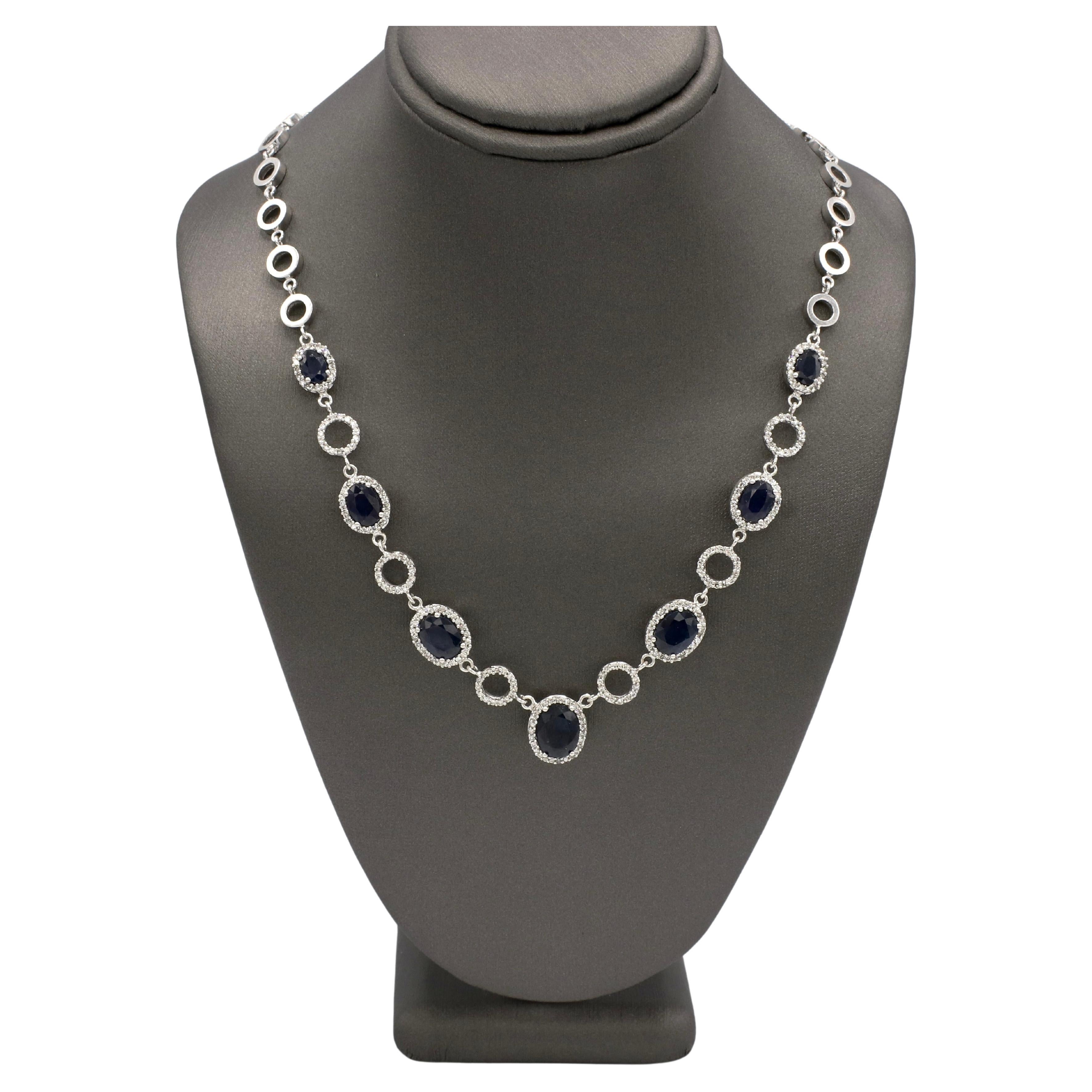 Effy 14 Karat White Gold Natural Sapphire & Diamond Station Circle Necklace 
Metal: 14k white gold
Weight: 23.32 grams
Length: 16.5 inches
Sapphires: 7 natural oval blue sapphires, approx. 9.50 carats
Diamonds: Approx. 0.90 CTW round natural