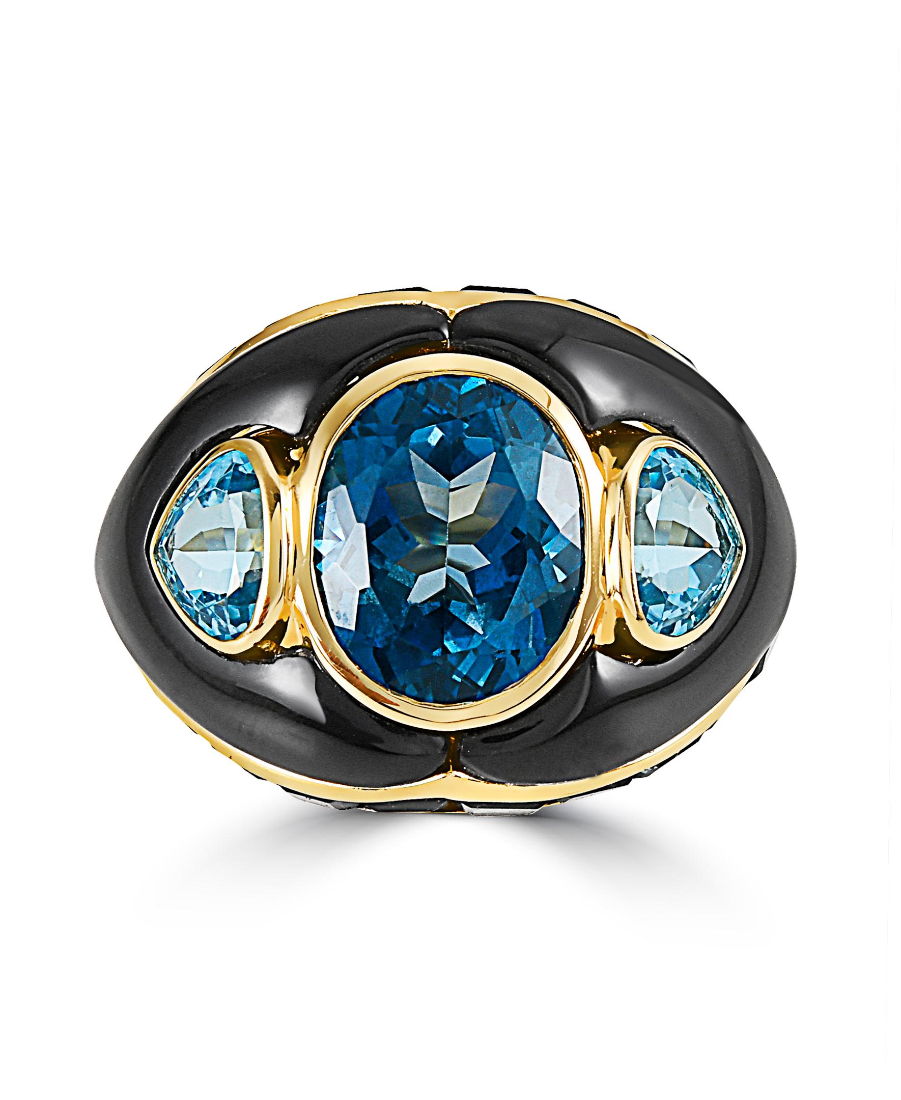 This Effy design ring is set in 14K yellow gold. 
This ring has London and Swiss blue topaz in oval and fancy shapes and their total weight is 12.66 ct.
The Onyx is in a fancy shape and the total weight is 5.54 ct.
This ring is a size 7. 
The item