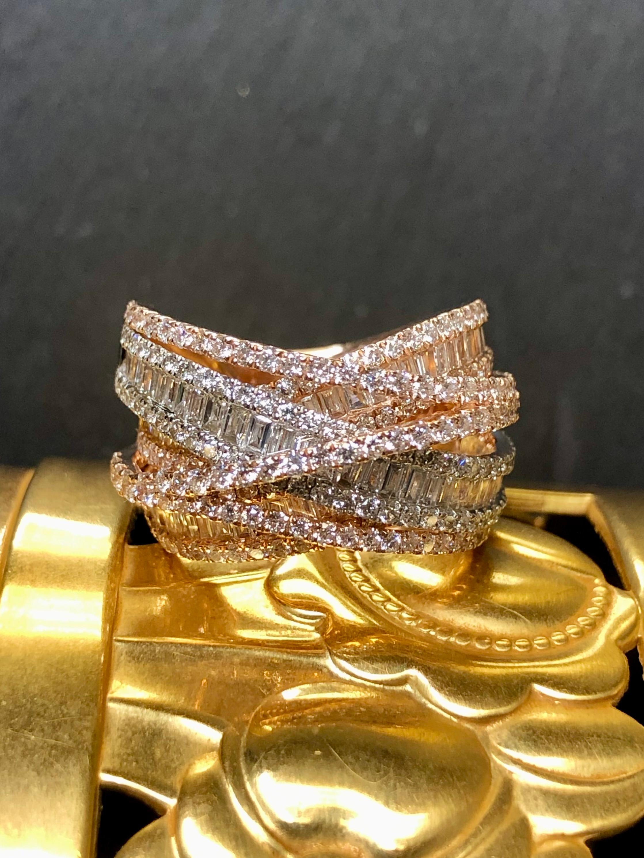 A fabulous crossover style ring by EFFY done in 14k rose and white gold both channel and bead set with approximately 4cttw in H-I color Vs1 to very clean Si1 round and baguette diamonds. Very sparkly and full of life… a gorgeous