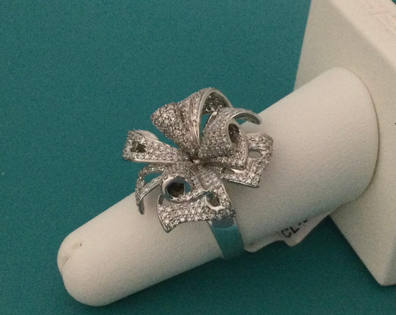 An exquisite EFFY ring designed in the shape of a large, open-petaled flower will look beautiful resting on a person's finger. Crafted from 14k white gold, the flower is lavishly encrusted with small, sparkling diamonds that cover each petal,