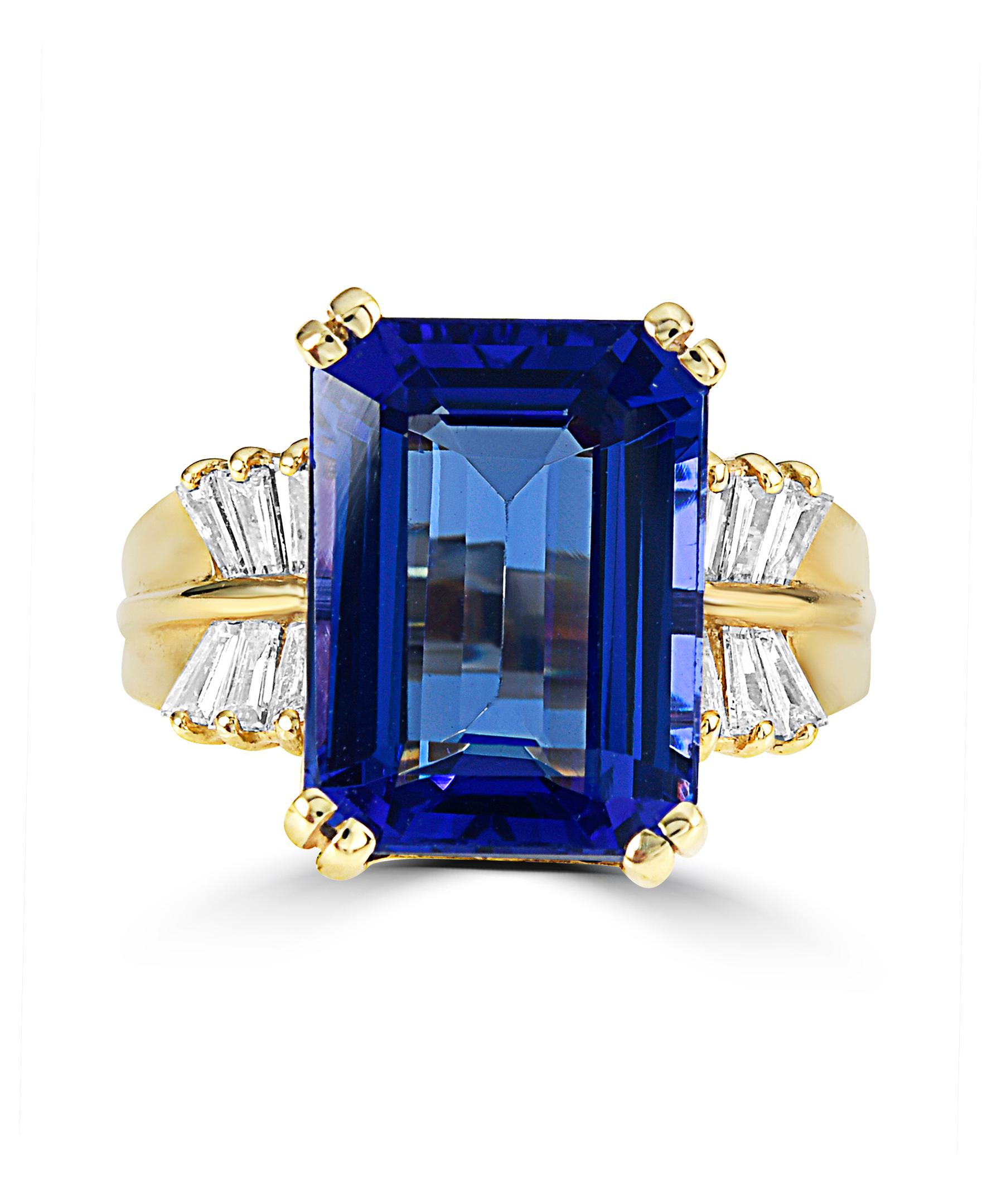 This Effy design ring is set in 18K Yellow gold. The design is set off with an Emerald cut Tanzanite, with a total weight of 9.16ct.
The diamond accent stones are baguette in shape and the total weight is 0.41ct.
This ring is a sizable 7. 
The item