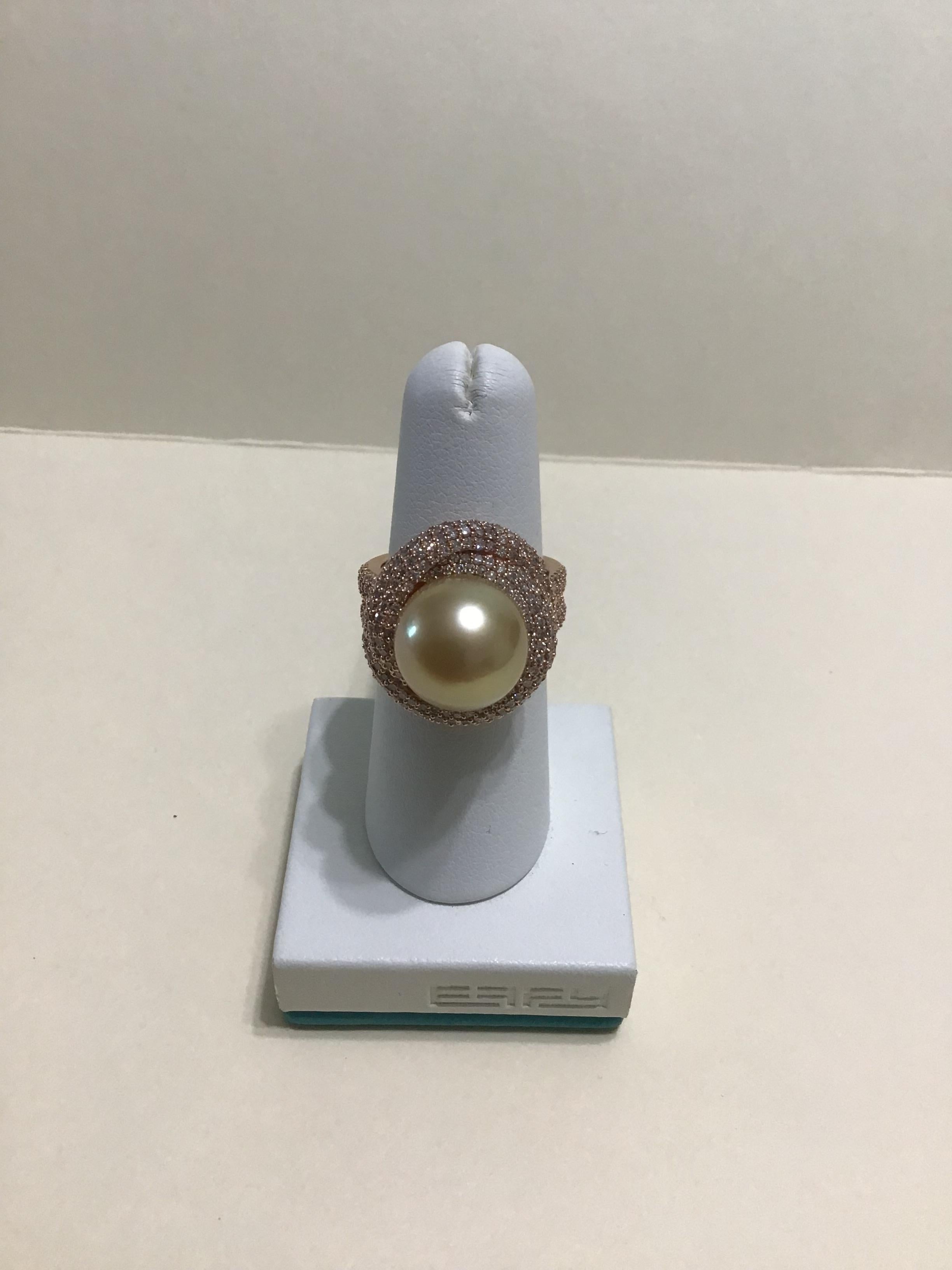 This EFFY ring is a stunning piece of jewelry that exudes elegance and sophistication. The 18K rose gold band is adorned with diamonds that sparkle and shine, adding a touch of luxury to the overall design. At the center of the ring is a beautiful