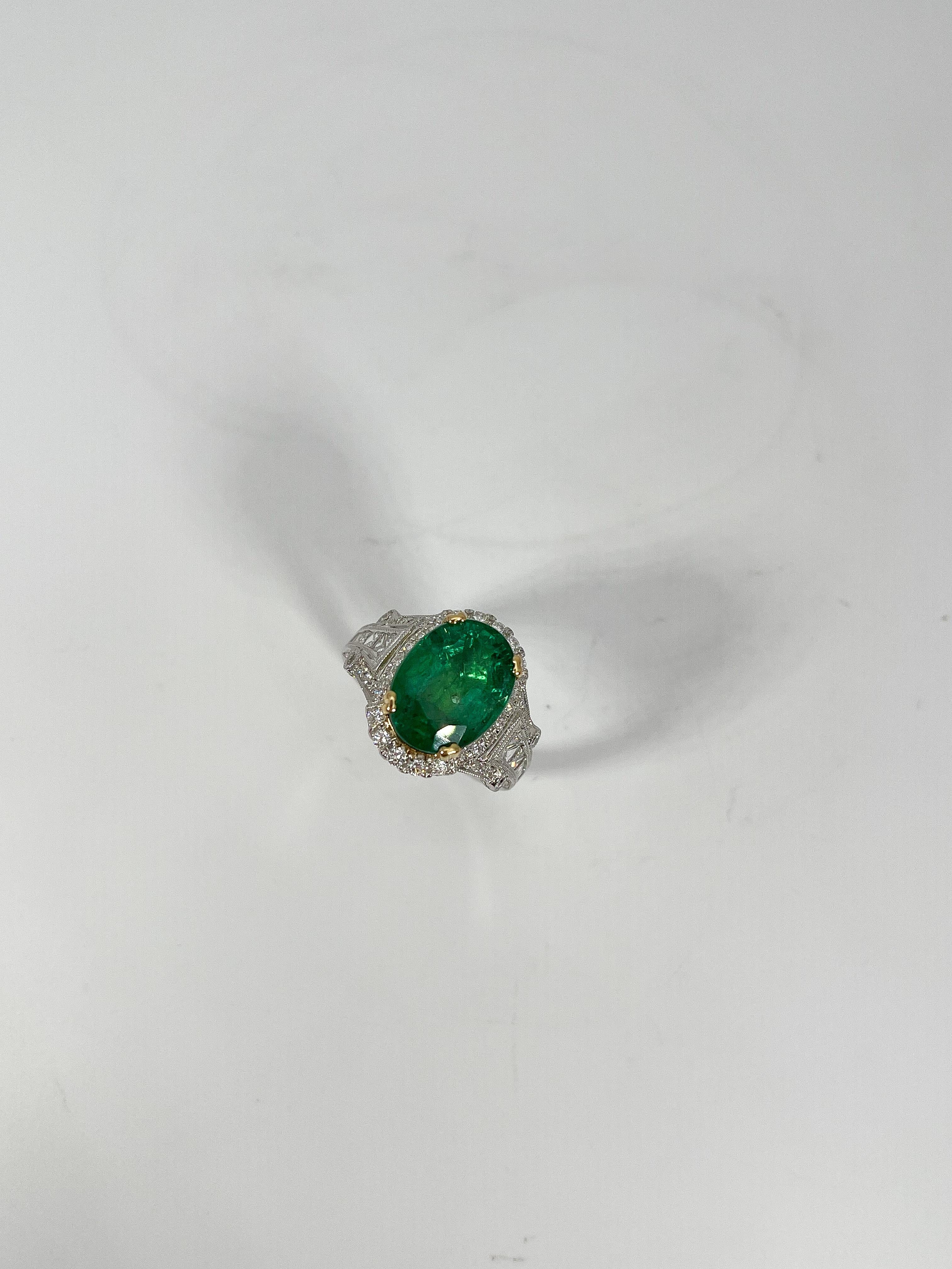 Ladies designer size 6 1/4 18k white and yellow gold ring by EFFY featuring an oval cut emerald accented with multi-shaped cut diamonds. The ring is hallmarked 18k 750 EFFY. Total item weight is 8.4 grams. Comes with AJI certification.
Emerald