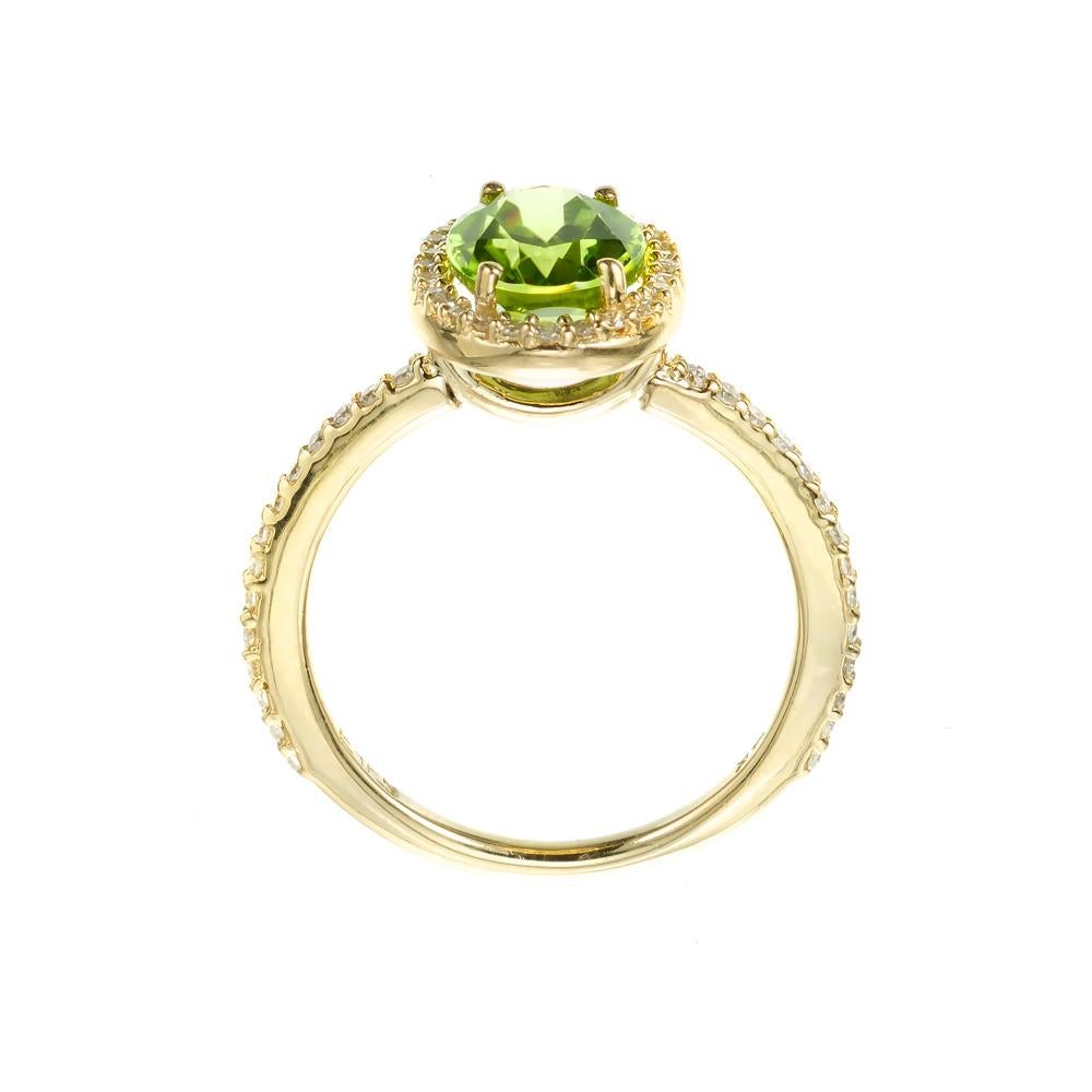 Bright green peridot and diamond ring from Effy. 2.00ct Peridot center stone, set in a 14k yellow gold setting with a halo of diamonds and round accent diamonds along the shank. 

1 oval yellowish green peridot, approx. 2.00cts
56 round diamond, I