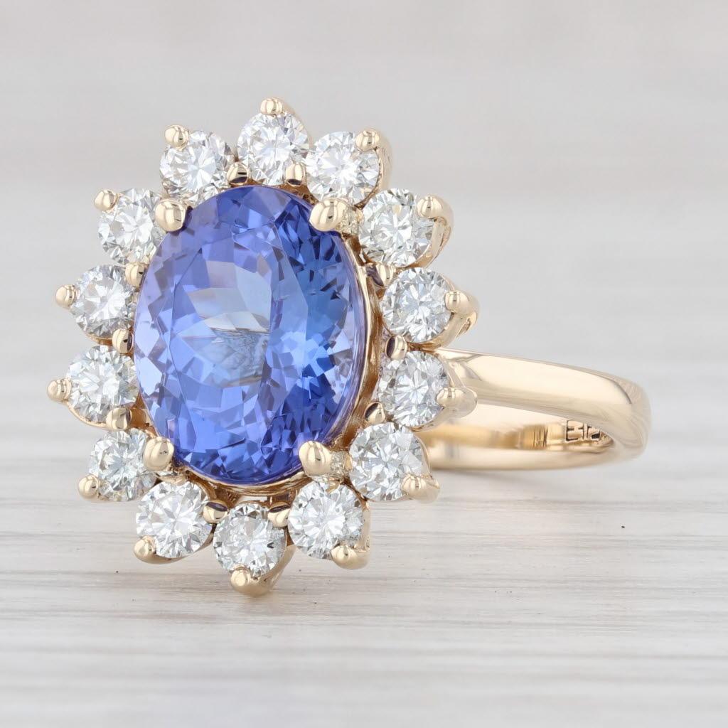 Gemstone Information:
*Natural Tanzanite*
Carats - 3.75
Cut - Oval Brilliant
Color - Dark Purple Blue
Treatment - Heating
*Natural Diamonds*
Total Carats - 0.68ctw
Cut - Round Brilliant
Color - G - H
Clarity - VS2

Metal: 14k Yellow Gold
Weight: 4.8