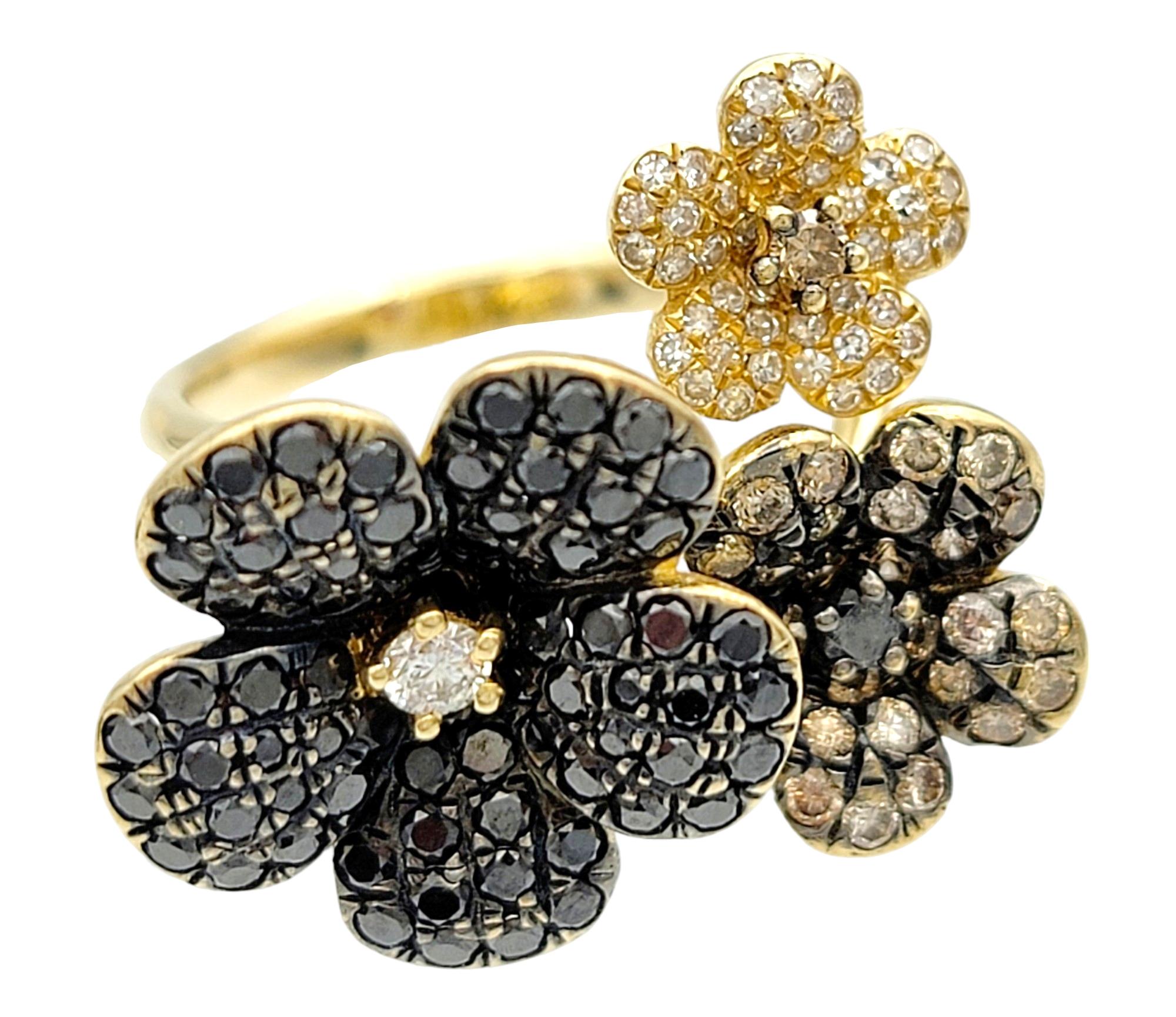 Ring Size: 5.25

This Effy diamond flower ring is a stunning piece set in 14 karat yellow gold, featuring three enchanting flowers of varying sizes. Each flower is adorned with a unique color of diamonds, creating a captivating display of