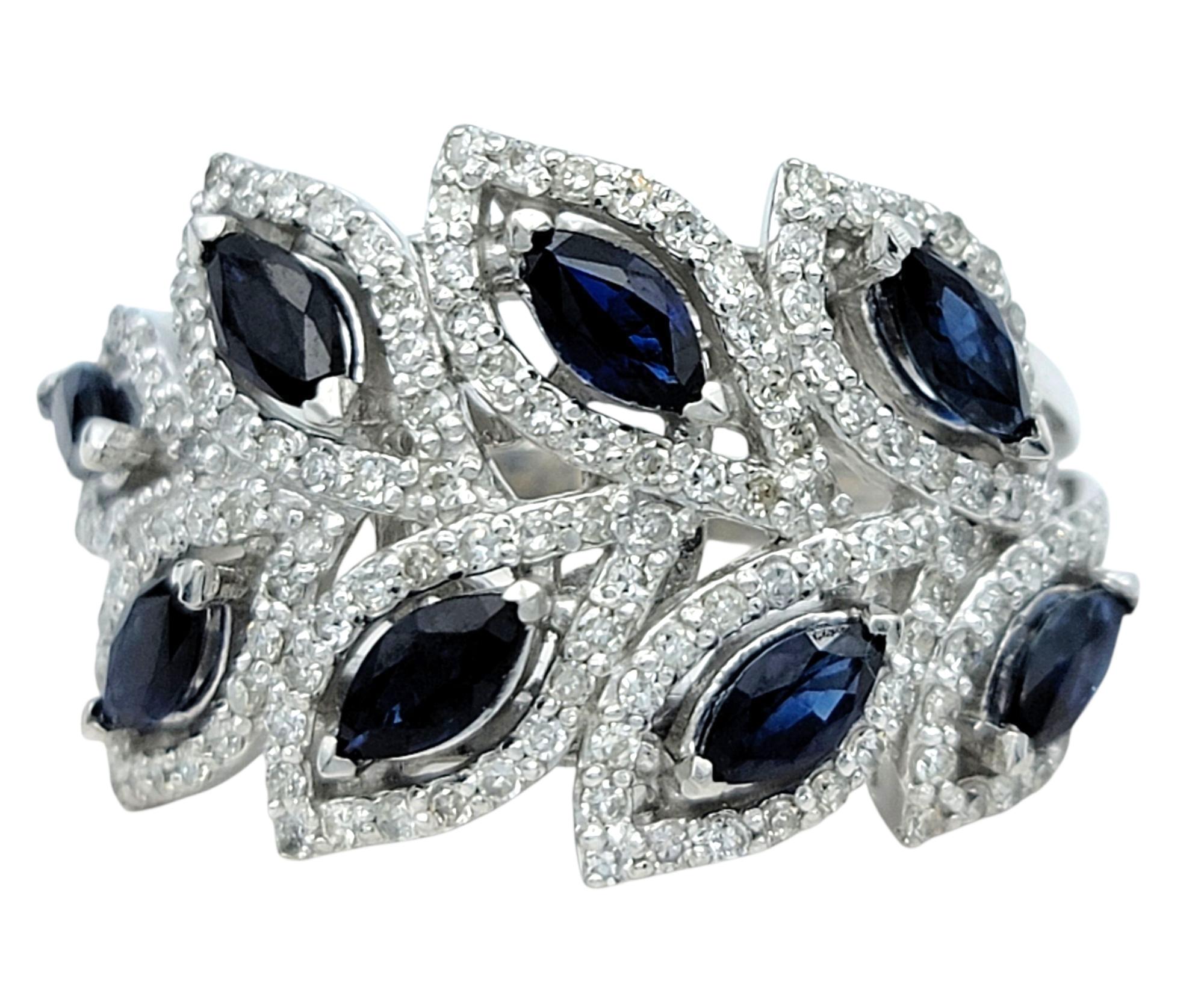 Ring Size: 7

This striking ring features a bold wave of marquise-cut blue sapphires, elegantly arranged in a staggered formation across the front. Set in polished 14 karat white gold, the sapphires are framed by a dazzling sea of white pavé