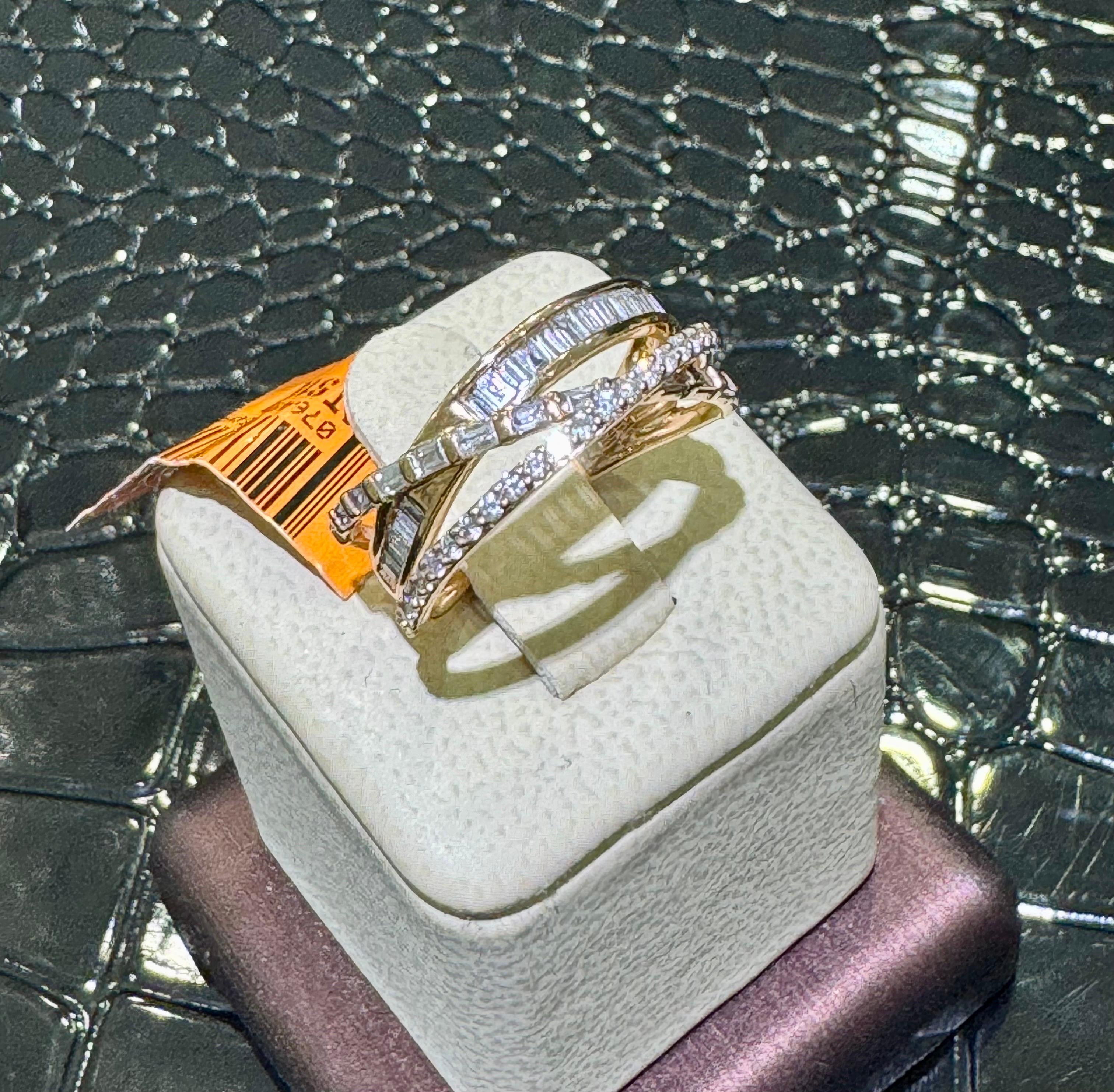 Contemporary Diamond Ring In 14k Rose Gold.

Approximately 0.77 carats in baguette and round diamonds,

Size 7.