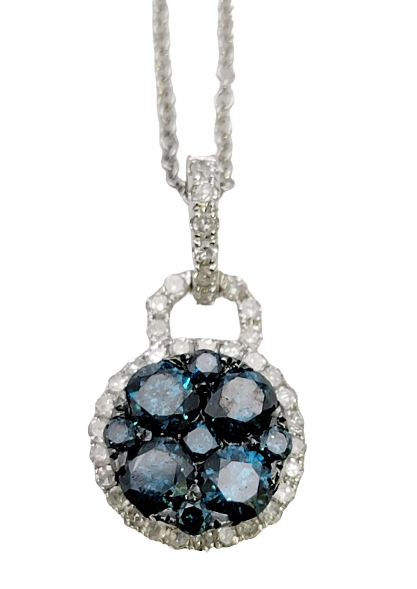 This sparkling contemporary diamond pendant necklace by EFFY is dainty and modest, yet undeniably beautiful. Brilliant fancy blue natural diamonds fill the center of the pendant, while icy white diamonds surround the blue stones a glittering halo.