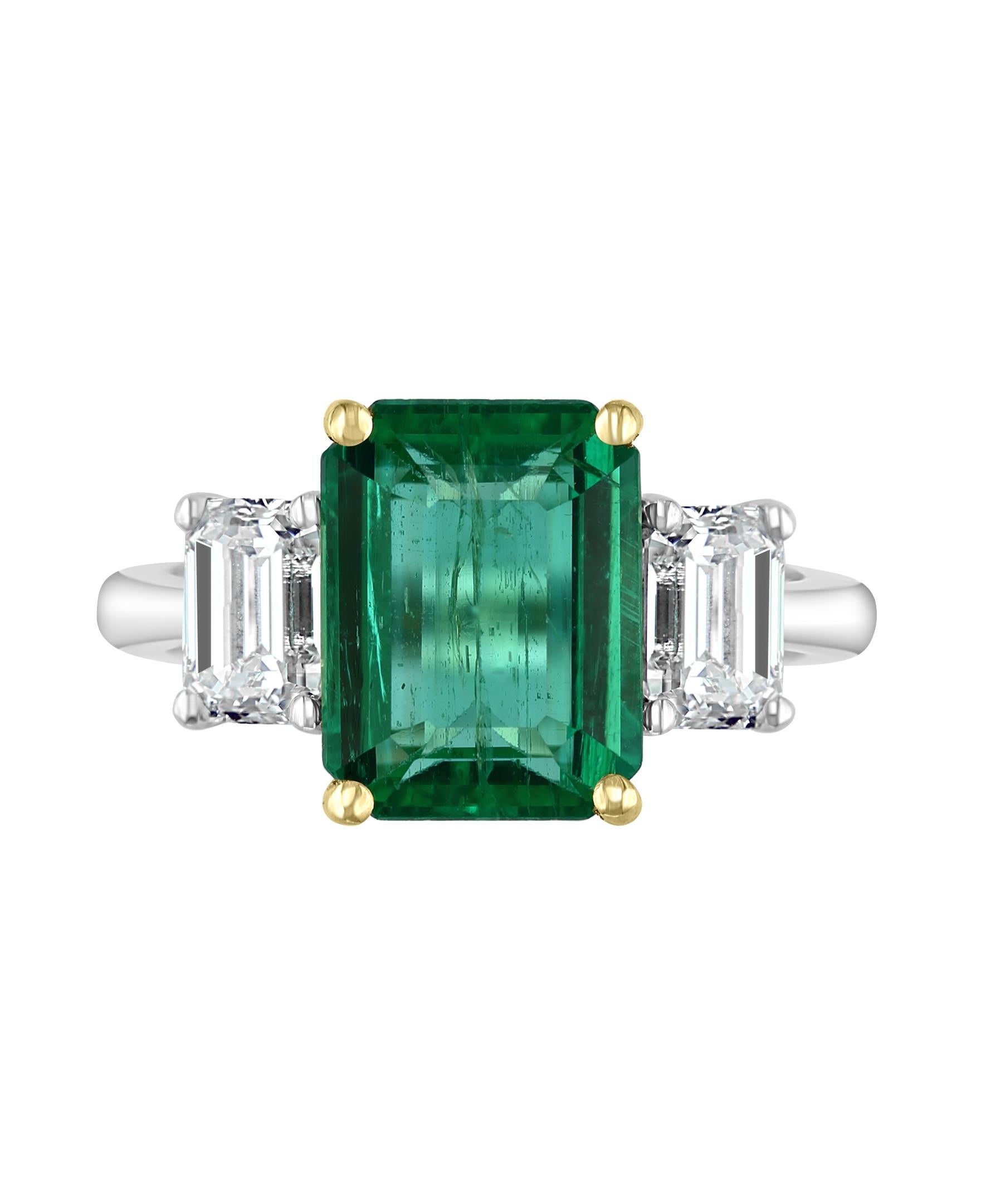 This Effy Hematian design ring is set in 18K White Gold, with 18K Yellow gold prongs holding the center stone Emerald. 
The center stone Emerald is an Emerald cut shape and weighs 3.29 ct.
Surrounded by two baguette cut diamonds with a weight of