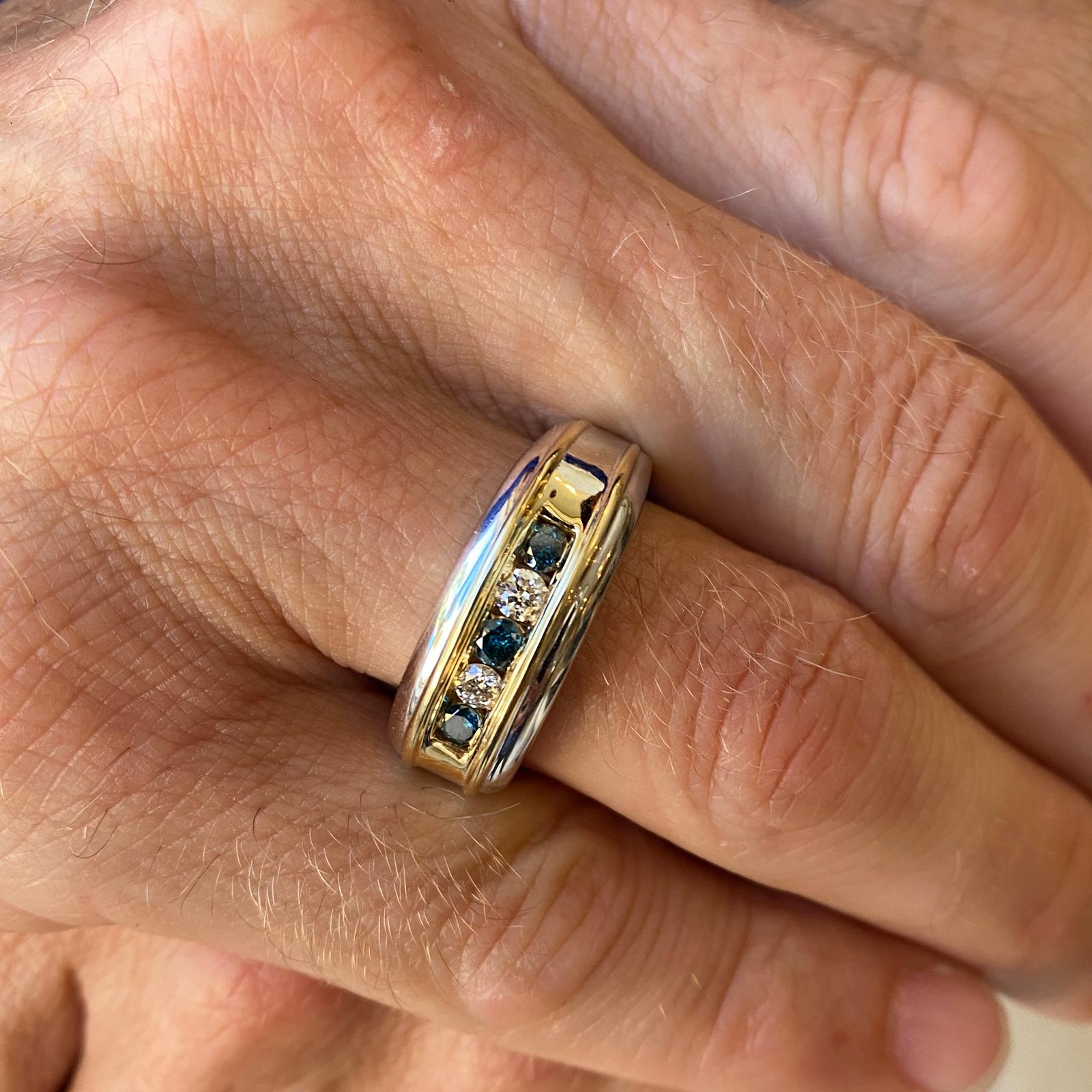 Fabulous men's blue and white diamond ring by designer Effy. The band is fashioned in 14 karat yellow and white gold. The ring features 5 alternating white and blue (assumed to be treated) round brilliant cut diamonds weighing .50 carat total