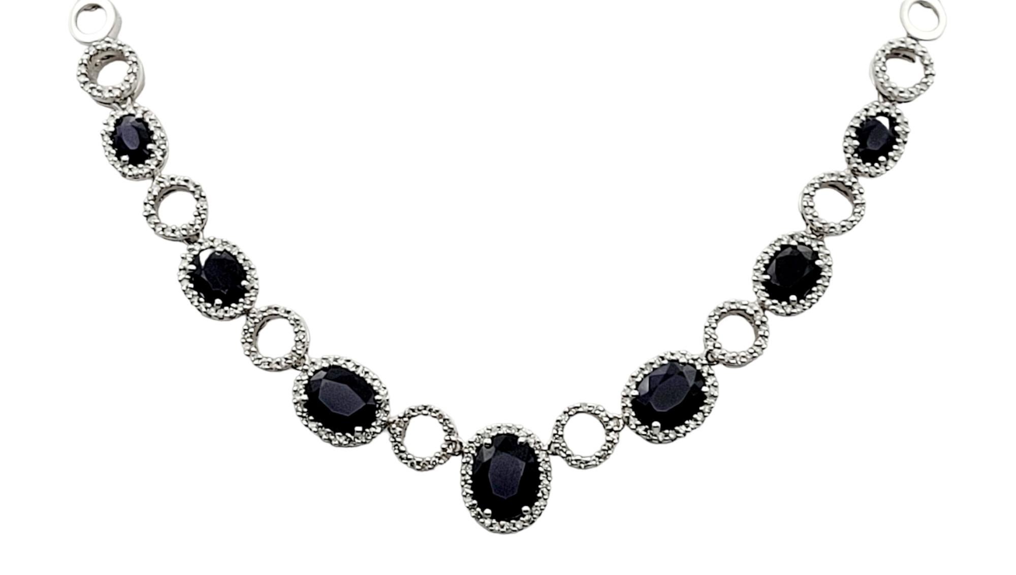 Incredibly gorgeous sapphire and diamond necklace with a rich, elegant pop of color. This fantastic piece absolutely dazzles with its dark blue sapphires and icy white diamonds. The striking necklace sits elegantly across the chest, sparkling from