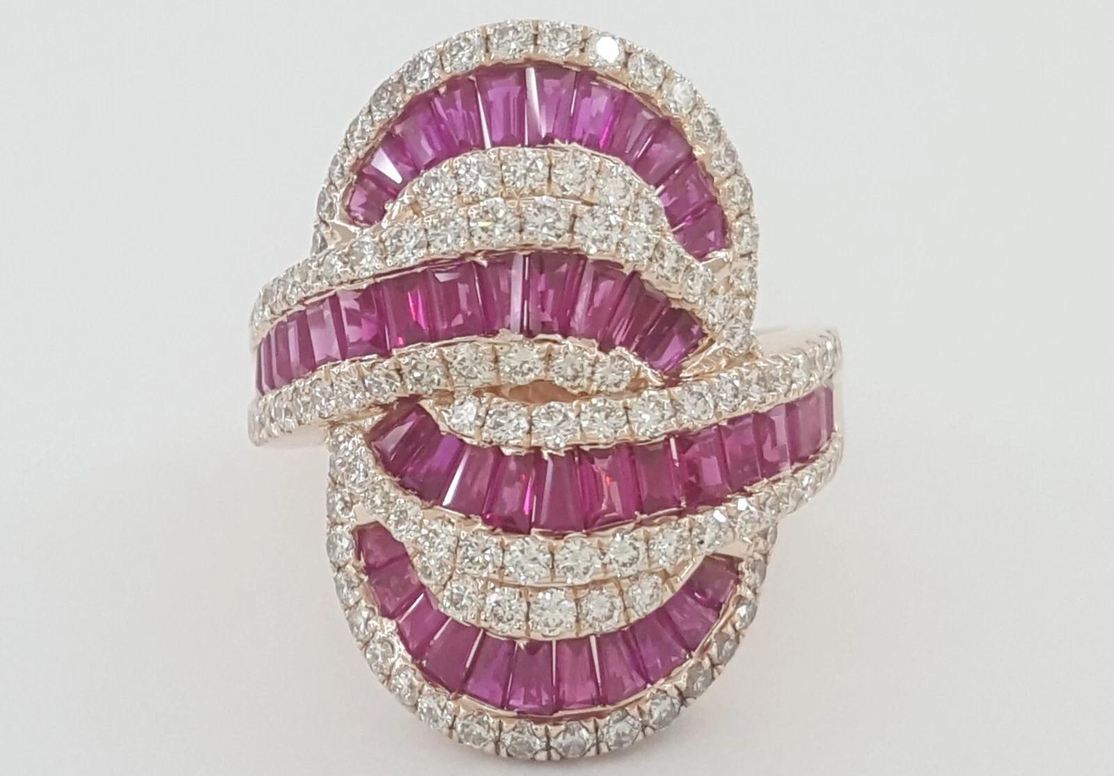 This striking statement ring by Effy showcases a bold composition of pinkish-red natural rubies and white diamonds, all set in warm 14K rose gold.

Gemstones: 48 natural baguette-cut rubies and 110 round brilliant-cut diamonds

Total Carat Weight: