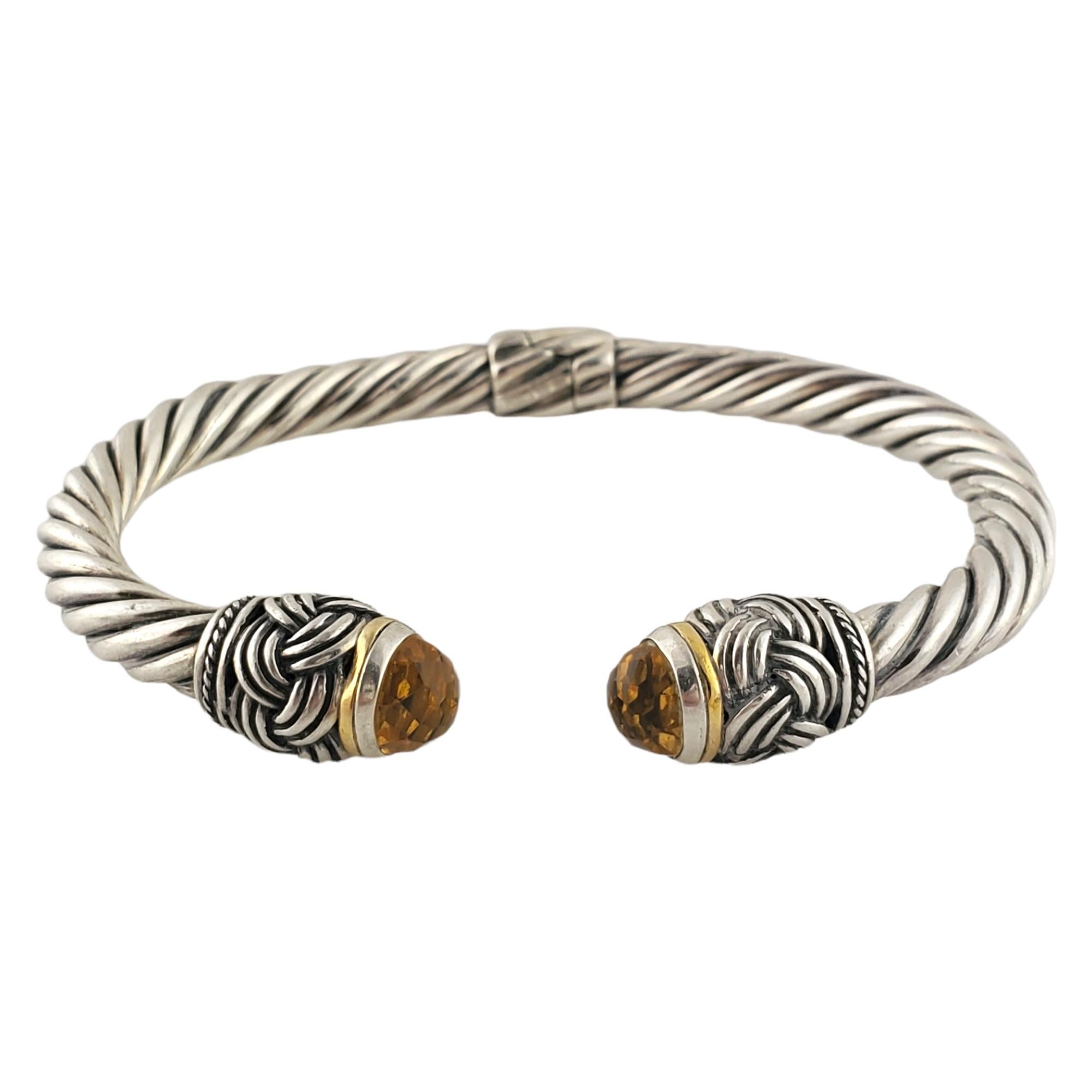 Sterling silver, 18K yellow gold plated and citrine hinged cuff bracelet by designer EFFY.

Classic cable design design cuff with faceted citrine stones on each end surrounded by 18K yellow gold bezel and silver braid detail. Hinged at