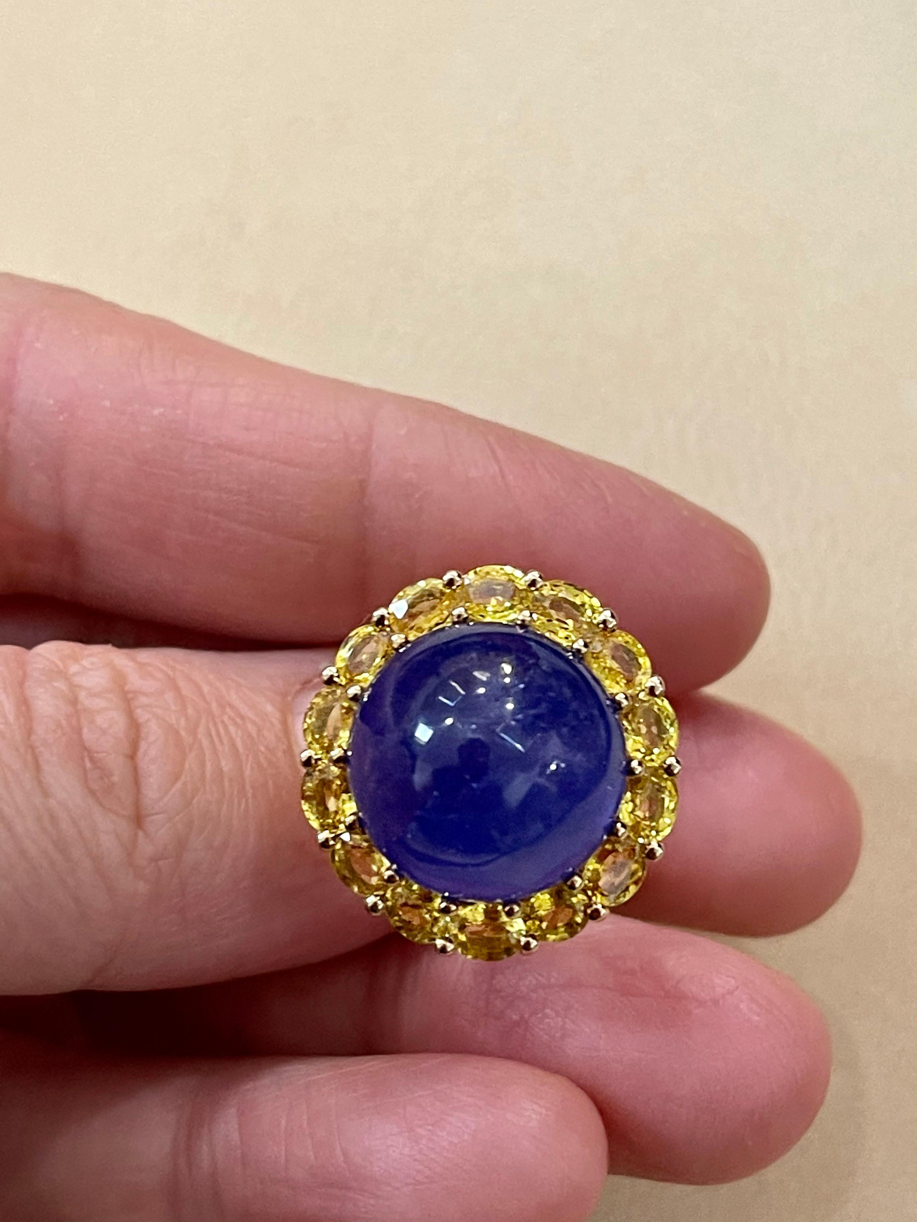Effy's 15 MMCabochon Tanzanite & Yellow Sapphire  Ring 14 Karat Yellow Gold
14 Karat yellow Gold 10 Grams
Cabochon Tanzanite surrounded by 14 Round Yellow Sapphire each 4X3 MM
Ring Size 7  ( it can be resized to any size for free of charge)

All our