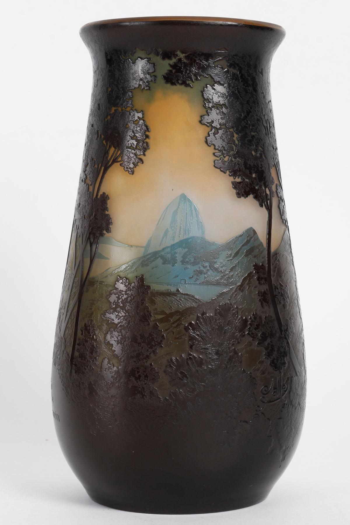 Emile Gallé (1846-1904)
French Art Nouveau Caméo Glass Vase « Rio de Janeiro » circa 1900

Rare Galle French cameo glass vase in dark blue over yellow 
Rio De Janeiro design showing the mountains, forest and the city coastline, 
Engraved on the side