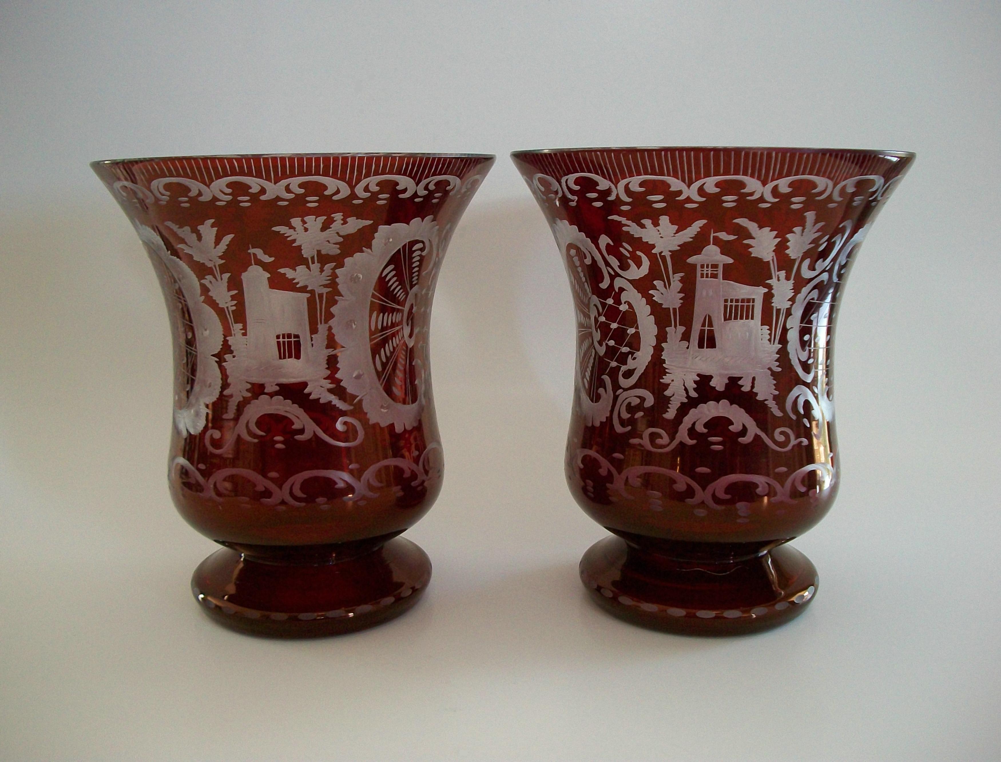 EGERMANN GLASS - Vintage pair of Bohemian ruby flashed wheel cut to clear glass vases - flared design on smooth socle bases - featuring hand etched castles and hunting scenes with exuberant rococo style flourish and scroll details - flat polished