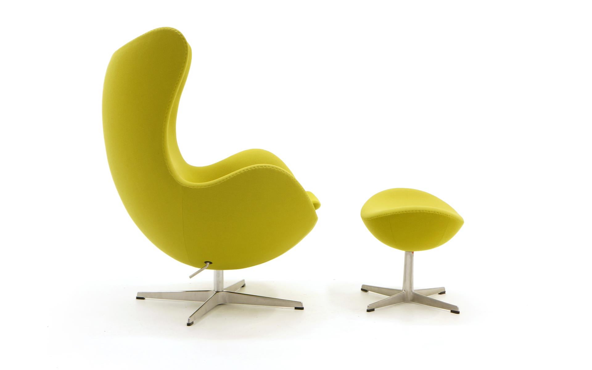 Original, authentic Arne Jacobsen Egg chair and ottoman made by Fritz Hanse, Denmark, 2008. Original chartreuse (yellow-green) fabric. The chair tilts and swivels making it very comfortable it recline.
Ottoman dimensions: 16.25 in. H x 15 in. D x
