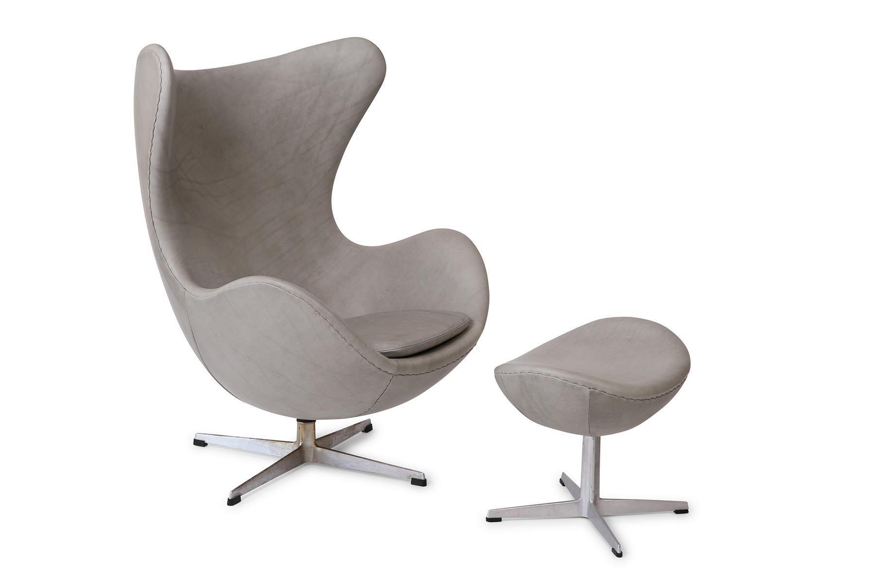 Arne Jacobsen for Fritz Hansen egg chair and ottoman, circa late 1960s. This stunning example has been newly upholstered in a supple and beautifully patinated light gray leather. Price listed is for the chair and ottoman.