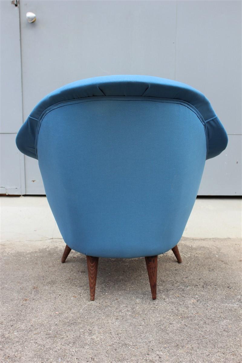 Egg enveloping armchair 1950s midcentury Italian modern blue gray wood feet.

It is very reminiscent of the style of the famous Italian architect Ico Parisi.