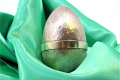 Egg in brushed gilded silver with a bouquet of flowers inside, Fabergé style