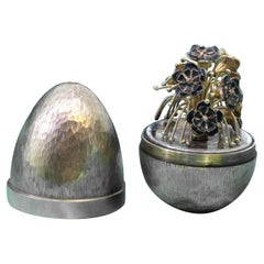 Egg in brushed gilded silver with a bouquet of flowers inside, Fabergé style