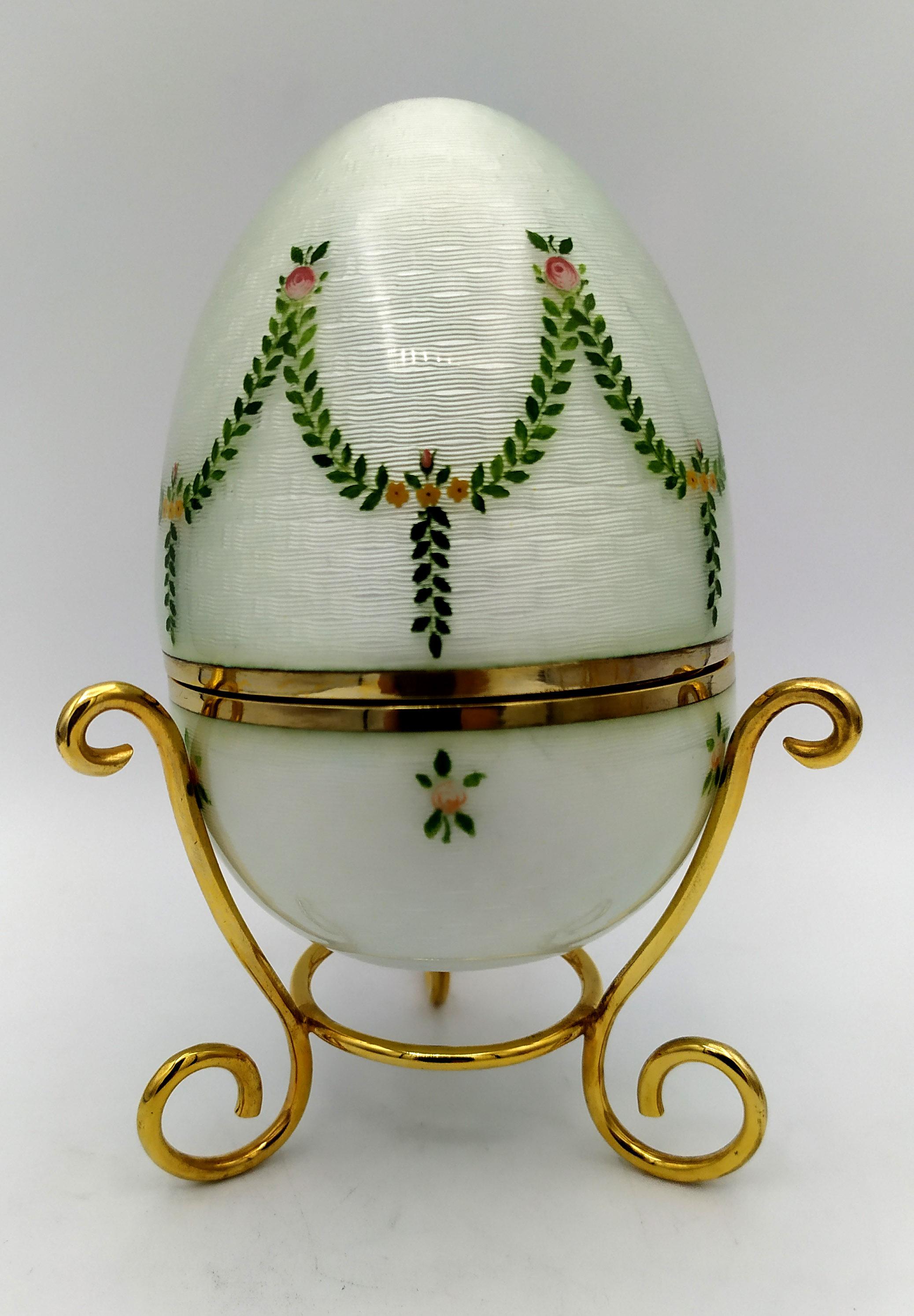 

Egg “music box” is in 925/1000 sterling silver.
Egg “music box” has fired enamels on guilloché and design engraved by hand.
Egg “music box”on smooth tripod containing a “music box” mechanism by the Swiss Maison Reuge
Egg “music box” is Russian