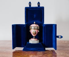 Egg-shaped clock with enamel decorations.