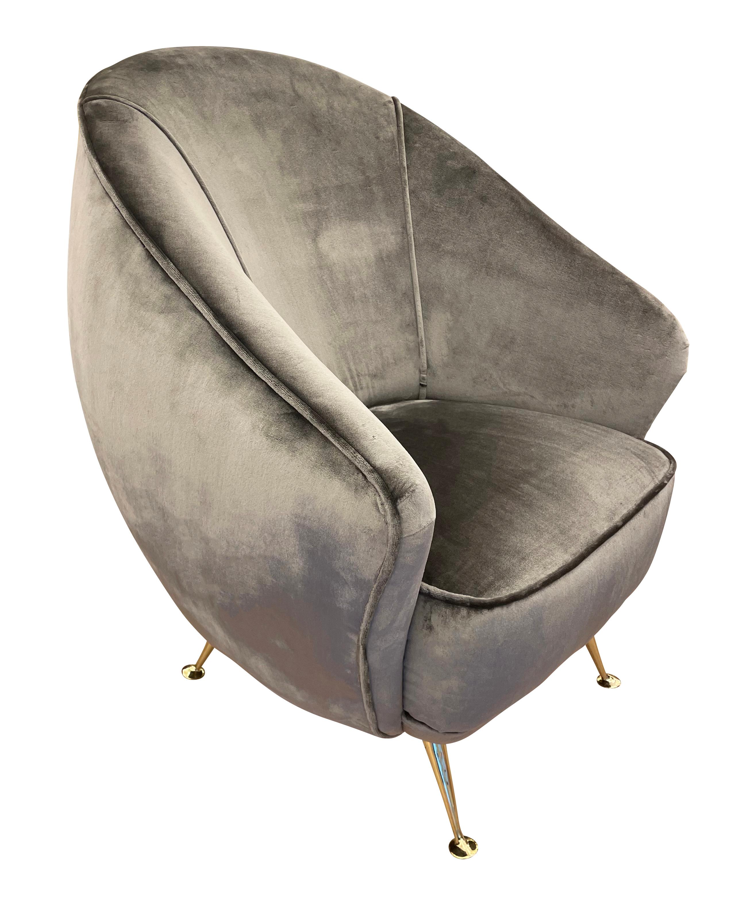 Pair of egg shaped Italian mid-century lounge chairs with brass feet. The fabric is a gray velvet. Pair can be split on request.

Condition: Excellent vintage condition, minor wear to the fabric.

Measures: Width: 29”

Depth: 29”

Height: