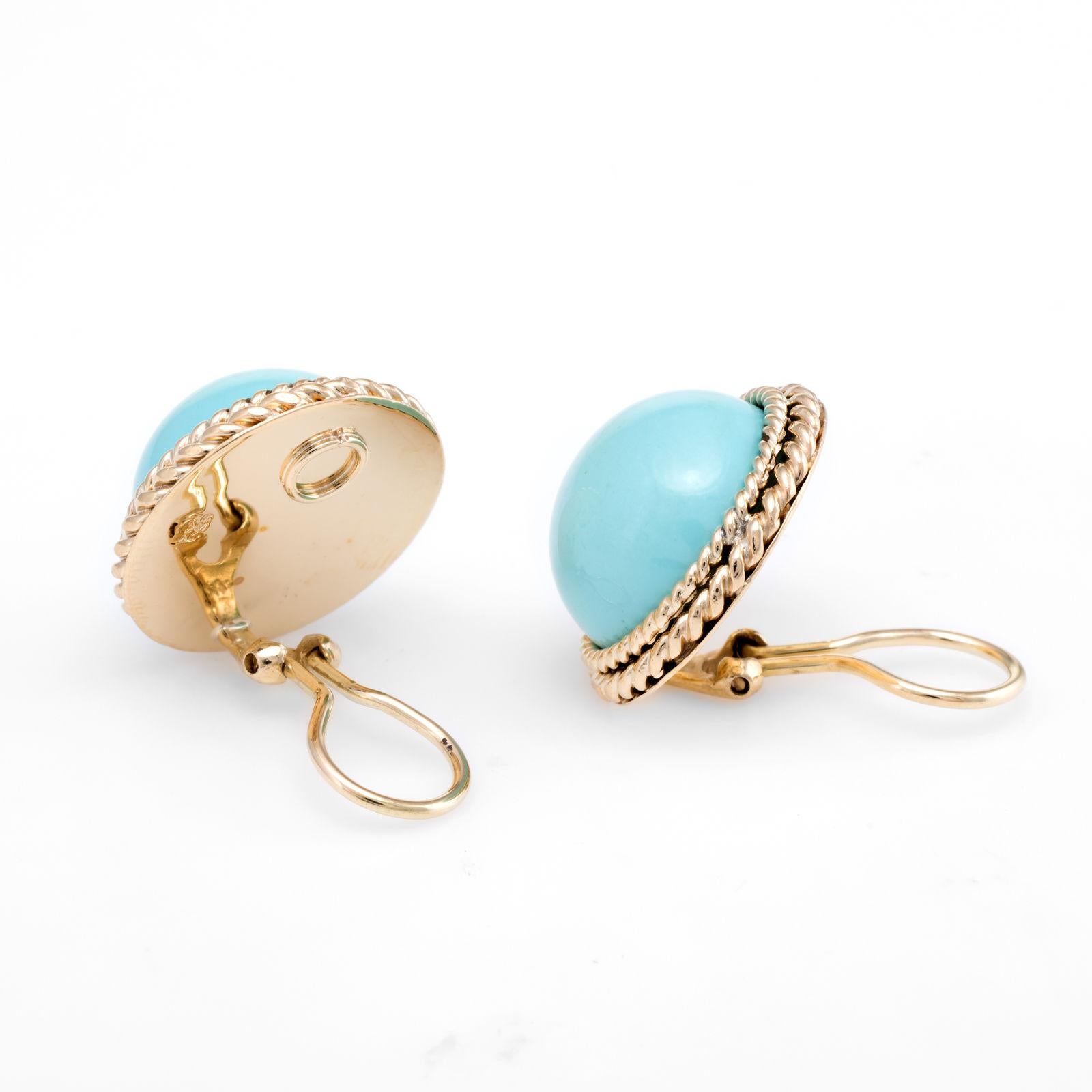 Elegant pair of vintage clip earrings (circa 1950s to 1960s), crafted in 14k yellow gold. 

Cabochon cut egg shell blue turquoise measures 16.25mm (each) and totals an estimated weight of 40 carats (20 carats each). The turquoise is in excellent