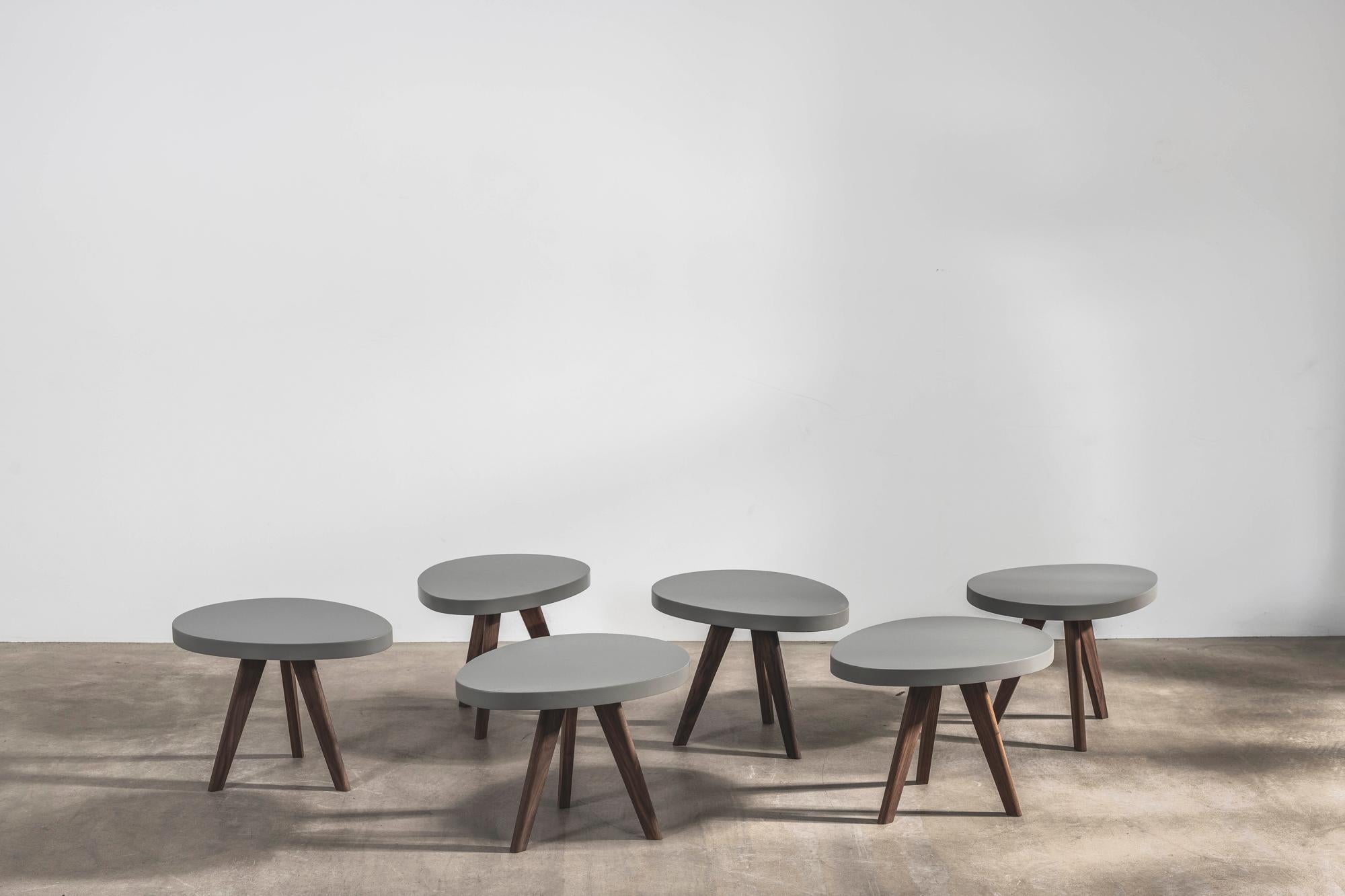 Inspired by nature, these playful egg-shaped side tables look good on their own and even better as a group. 

Designed by Russell Pinch, they have legs made from solid American walnut and a grey lacquered top. 
 