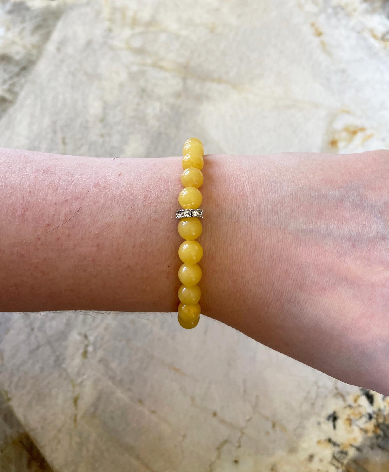Stunning stretch stacking bracelet made with round egg yolk Baltic amber (8mm) round beads and a Swarovski crystal accent bead. Handcrafted in the USA by Rocat Designs. This bracelet is approximately 7 inches (17.8 cm) long. The size is perfect on