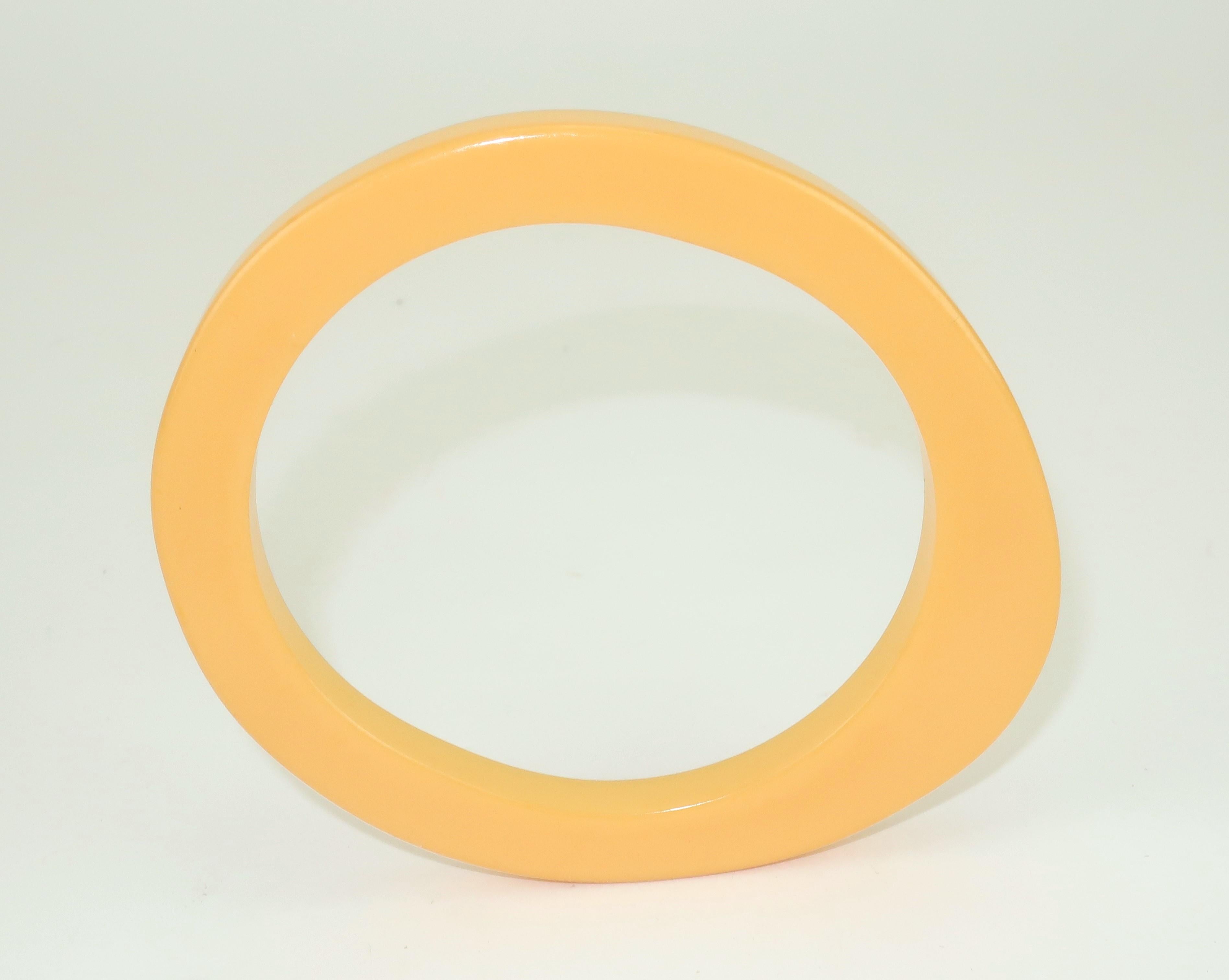 Breakfast anyone?  1940's Bakelite bracelet in a unique and eye catching oblong shape reminiscent of a fried egg which goes hand in hand with the yellowish color known as 'egg yolk'.  The skinny silhouette is fun on its own or equally stylish
