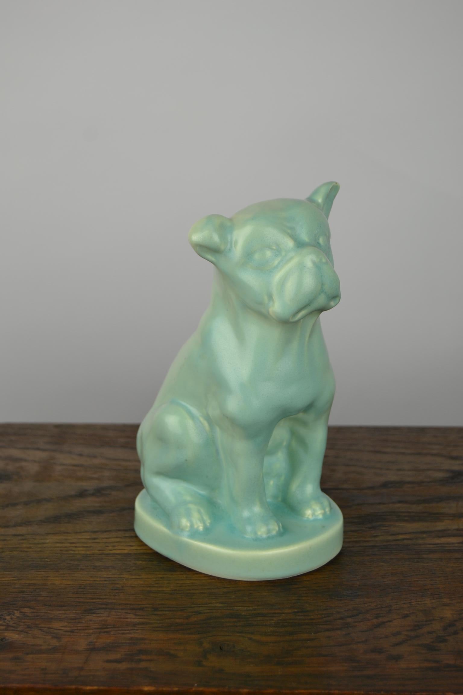 Charming porcelain French or English bulldog / bully / dog figurine
 in typical 1930s Art Deco mottled eggshell satin green.
Numbered at the bottom: 1216.

A very little chip on one ear and a minor Chip underneath the Base, when you turn him