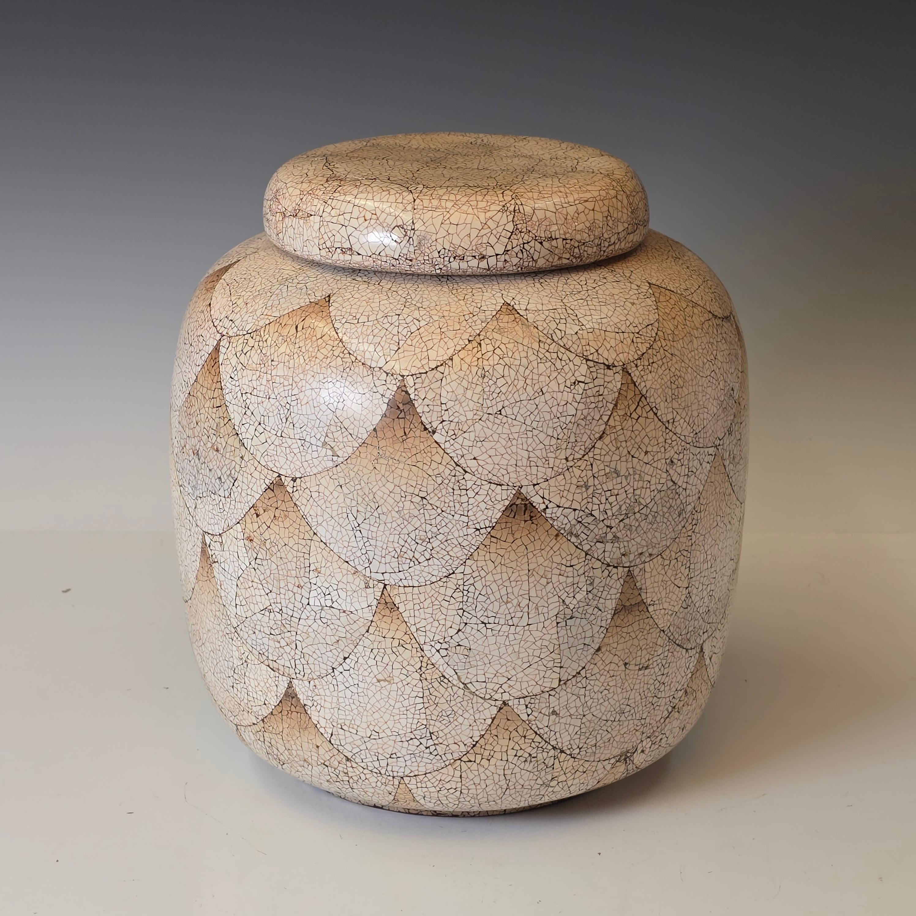 Stunning eggshell lacquer vase in the style of Jean Dunand featuring, thousands of small pieces of eggshell laid in a scale pattern in the lacquer.  Like a miniature mosaic and then the gaps are filled with lacquer and polished down and a toner