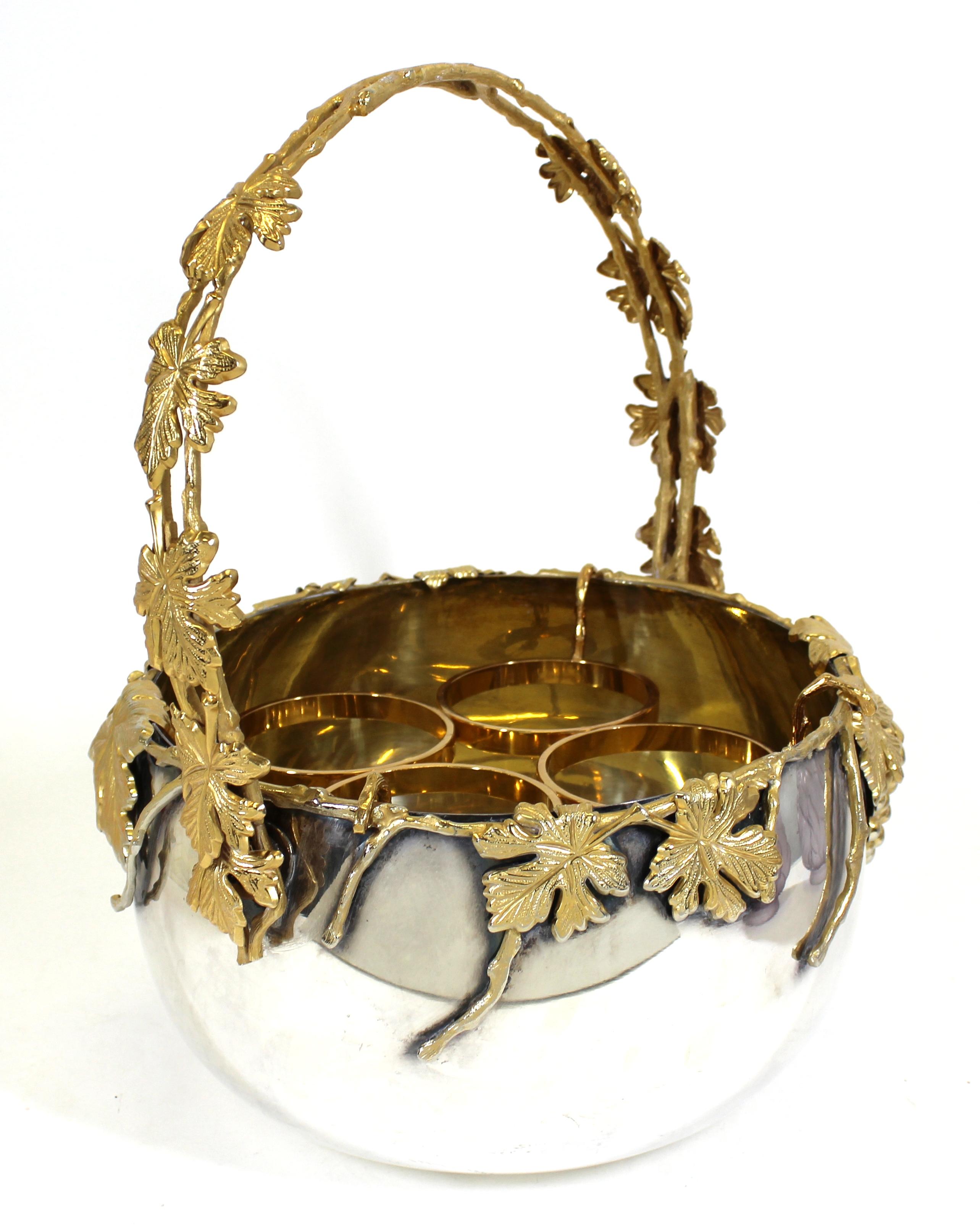 Italian Mid-Century Modern silver-plate and gilt wine cooler or champagne caddy, able to hold four bottles, made by Egidio Broggi in Milan, Italy. Ornamental gilt grape and leaf decoration on the handle and around the rim of the caddy. Retains its