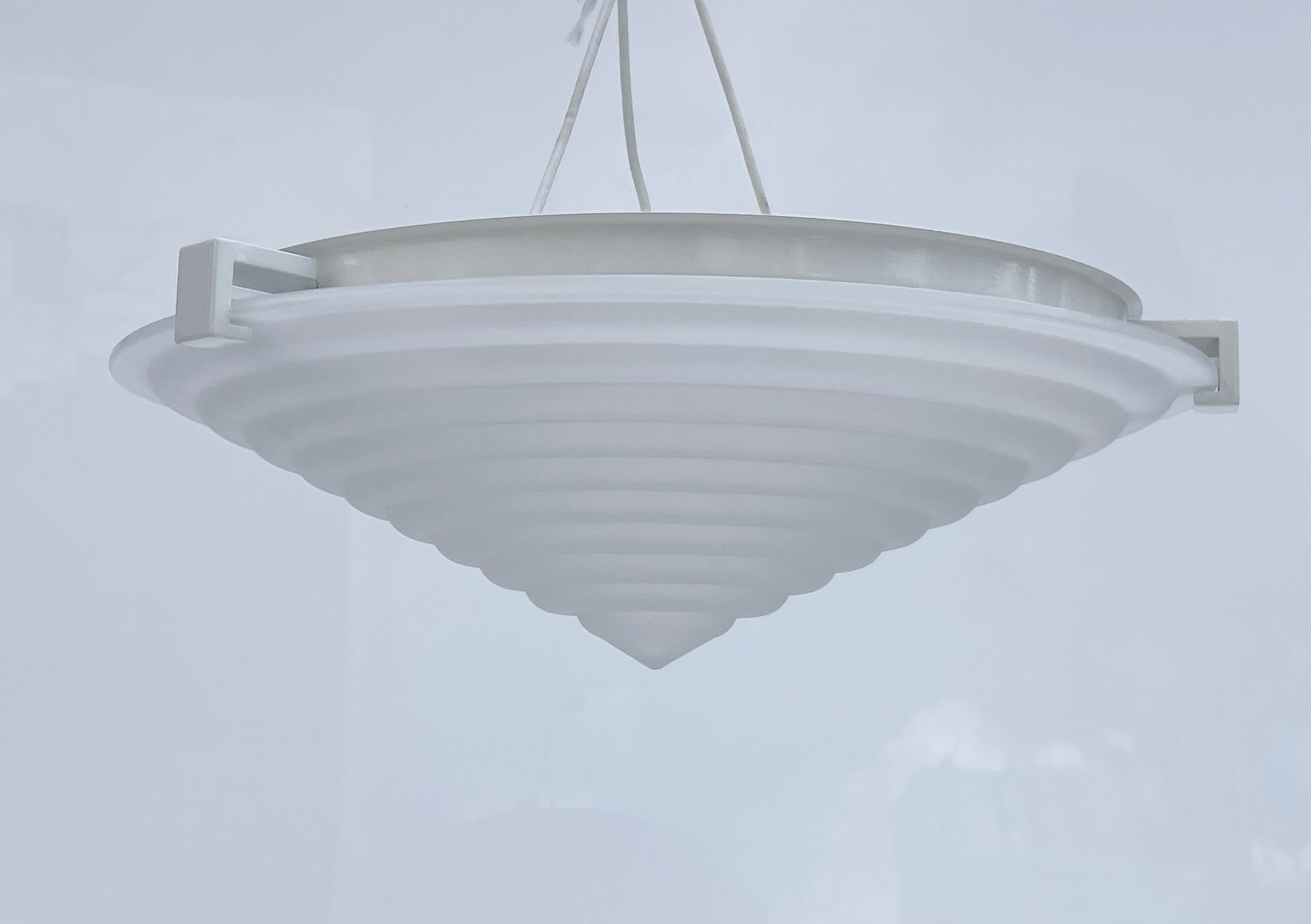 Beautiful ceiling light designed and manufactured in Italy by Angelo Mangiarotti for Artemide.
The piece has a beautiful frosted glass shade with a conical shape and a white metal frame.

Measurements:
16 inches in diameter x 6 inches high plus