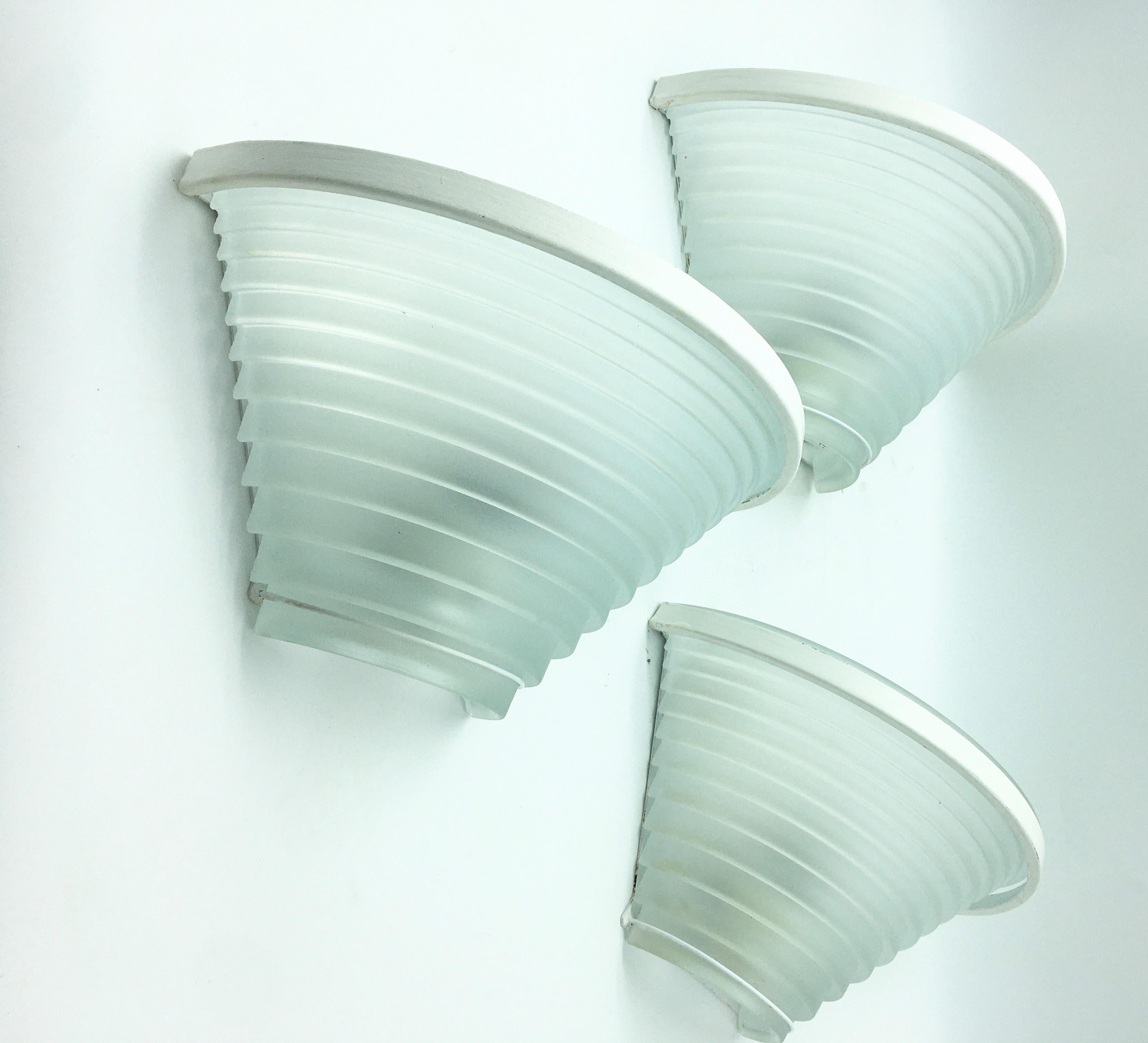 Italian vintage wall lights with white sanded glass shade on painted metal frame 
Designed by Angelo Mangiarotti for Artemide, circa 1980s, made in Italy
Original label on the frame.